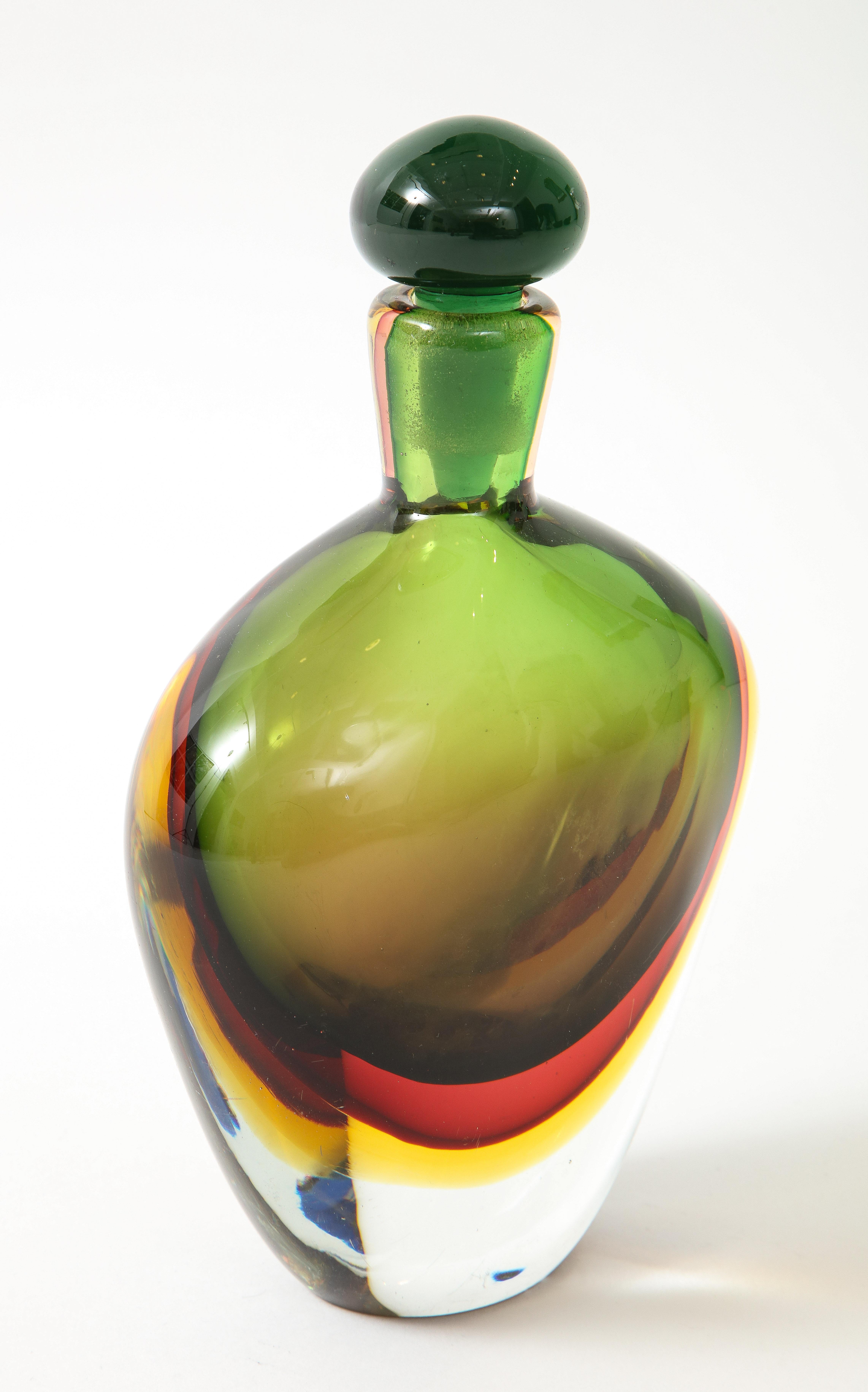 Seguso Vetri d'Arte elegant bottle with stopper, Italy, 1960s. This exquisite piece was made using the Sommerso technique of glassmaking in Verde Rosso Cinese Giallo colors - green, red, yellow. Although unsigned, it's documented in the Seguso