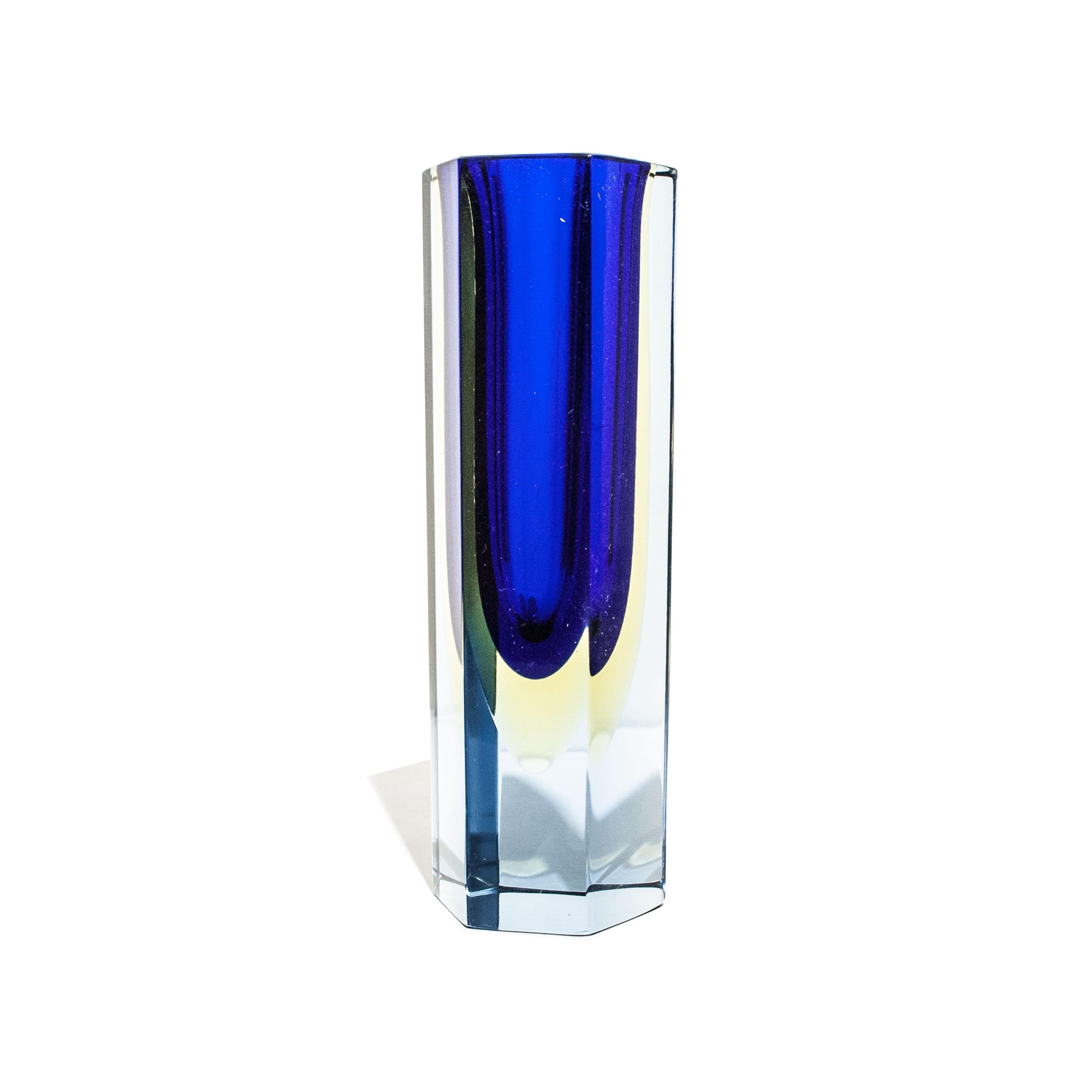 Italian small vase designed by Flavio Poli in the 1970´s. The vase is hand-crafted in faceted Murano glass in different colors with predominant blue.