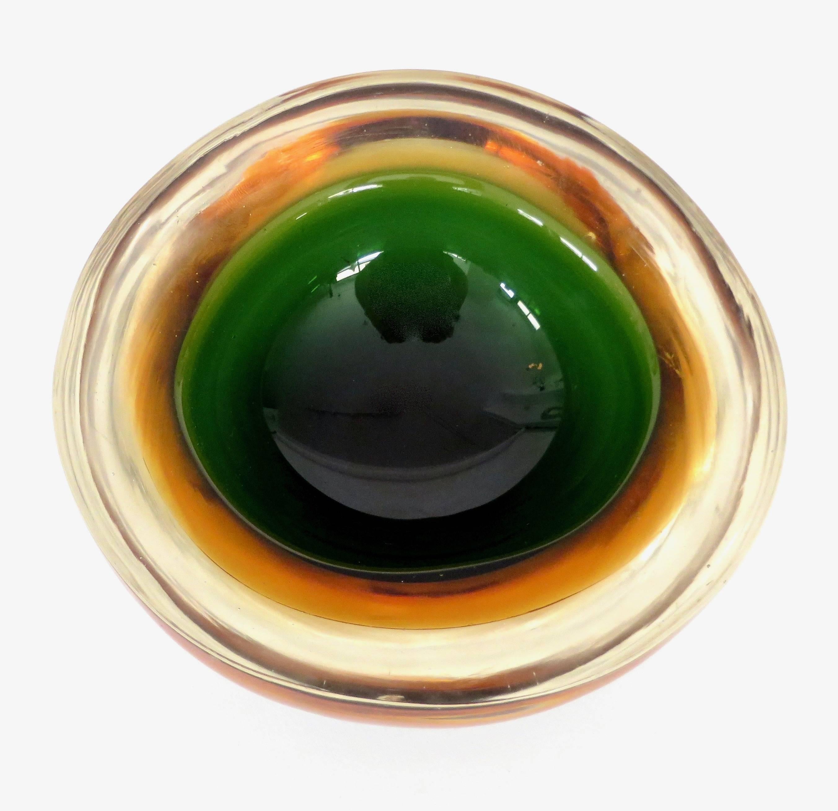 Flavio Poli Italian Sommerso Murano glass bowl in colors ranging from orange, green, green black and clear.
Very wonderful thick glass bowl to be used in many applications. Perfect condition. No chips.