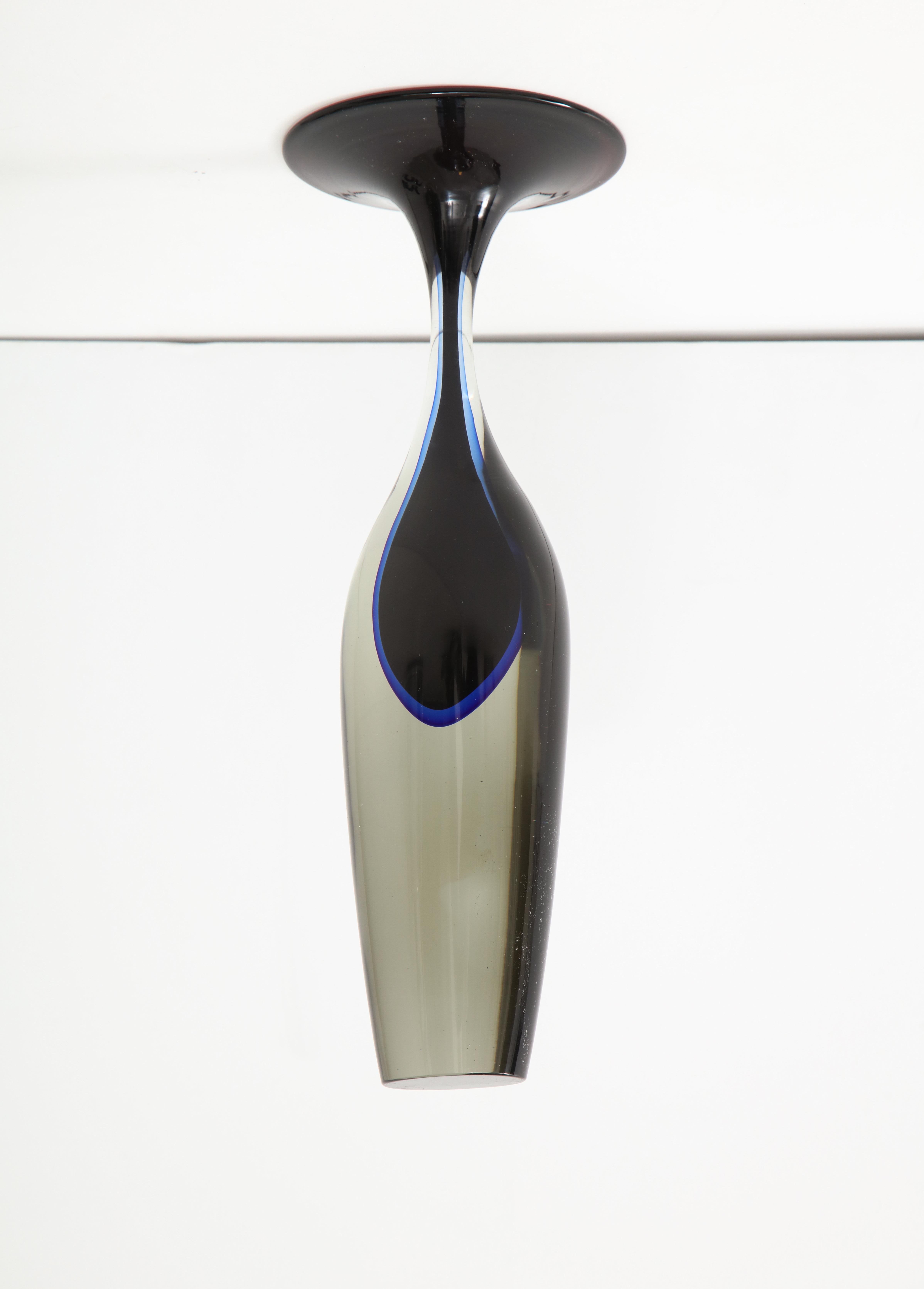 Midcentury Murano solid glass sculpture with a sinuous shape. A deep purple center is suspended within the thick smoked glass body. Sculpture can be oriented 2 ways.