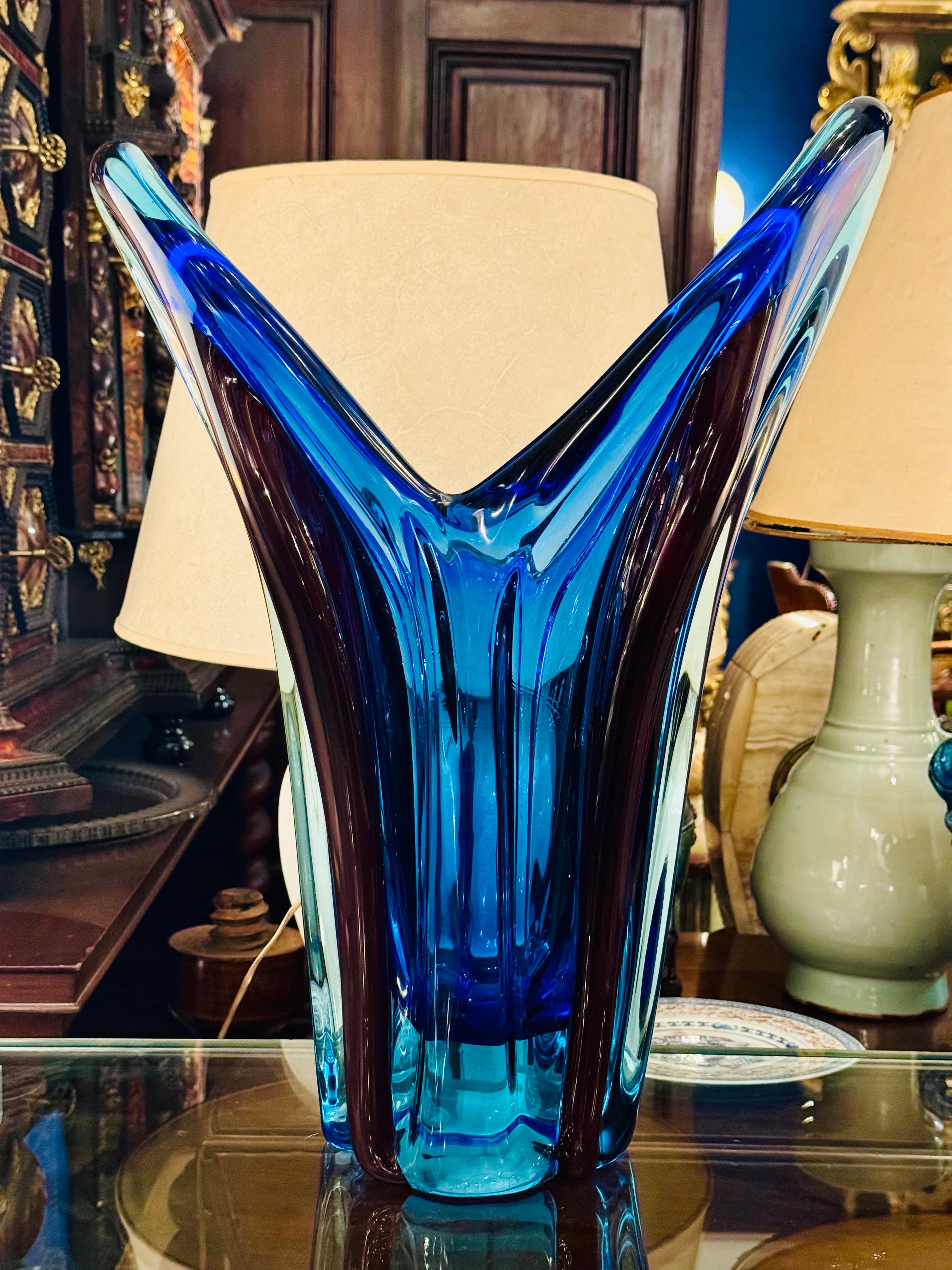 This exquisite Flavio Poli Murano glass vase showcases a stunning blend of blue, turquoise, and burgundy hues, creating a vibrant and dynamic visual experience. The flowing shapes and rich colors reflect the mastery of Murano craftsmanship, making