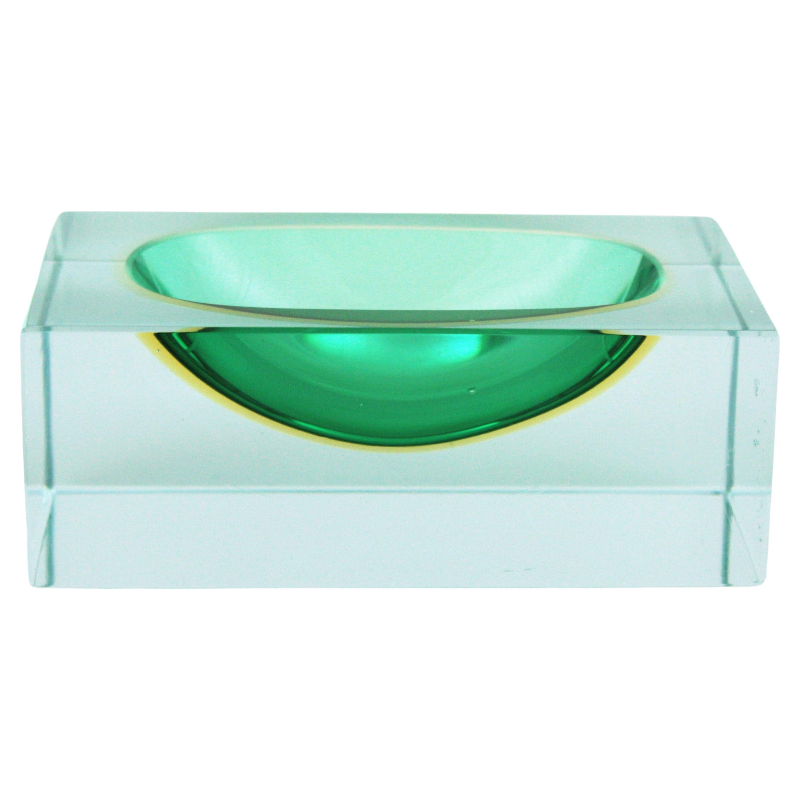 Faceted Sommersorectangular murano art glass block bowl. Attributed to Flavio Poli, Italy, 1950s.
Materials: Murano glass, Faceted.
Colors: dark green, yellow, clear glass
Eye-catching rectangular block cut faceted bowl, ashtray or vide-poche in
