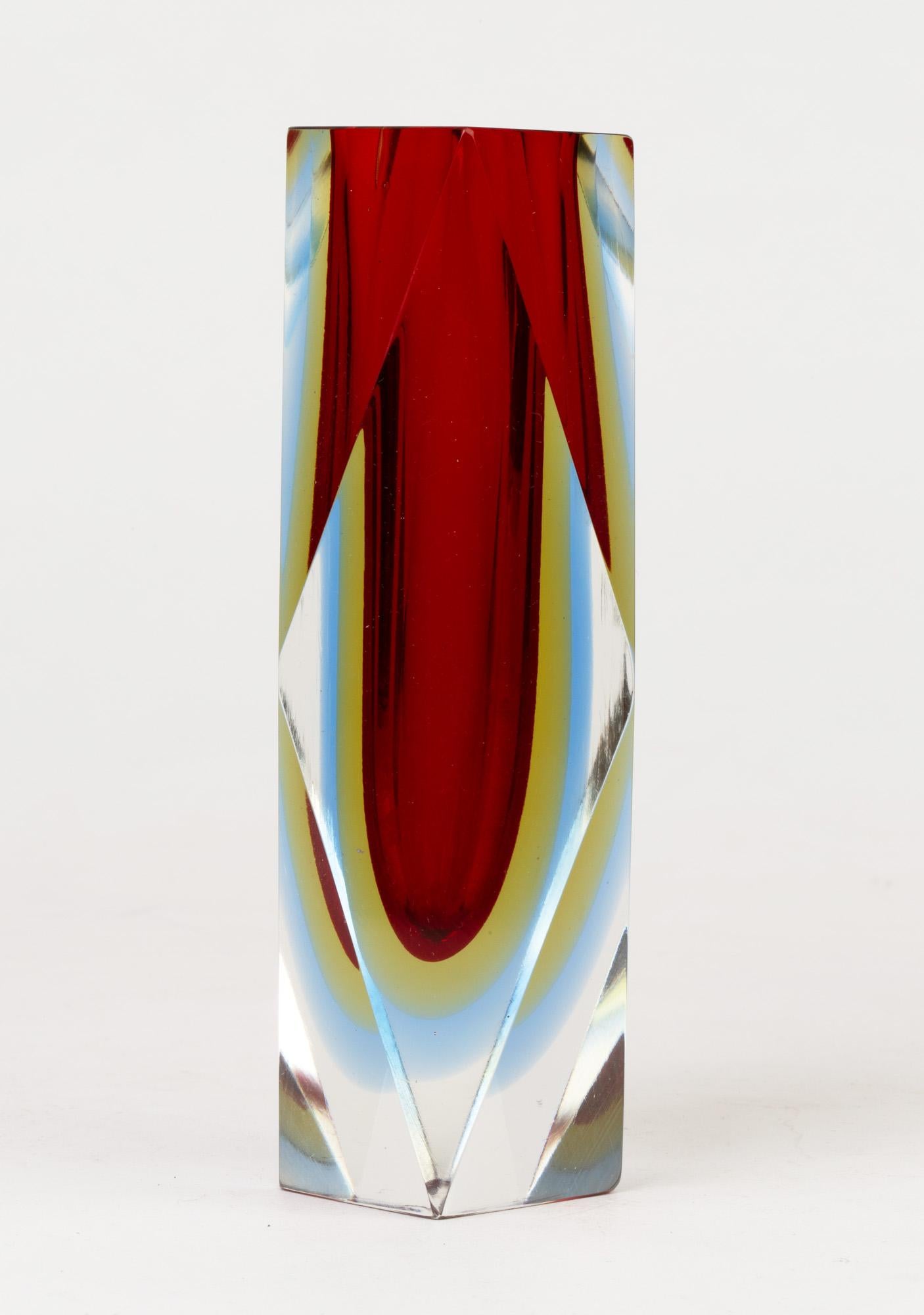 A very striking midcentury Italian Murano facet cut sommerso art glass vase with a double halo attributed to Flavio Poli (1900-1980). This finely and heavily made clear glass vase has a deep red centre with a yellow and blue tinted halo. The glass