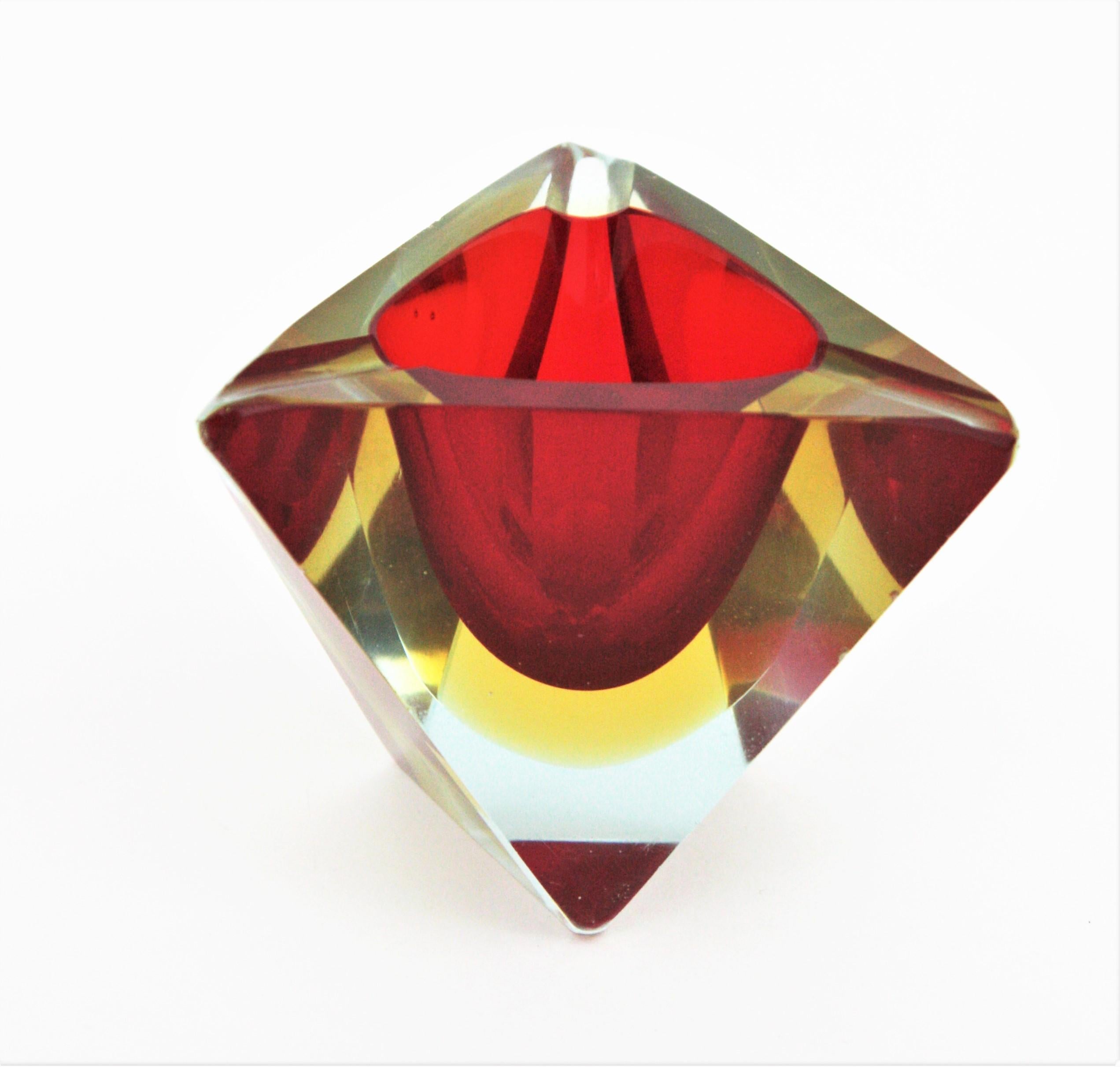 Sommerso faceted Murano glass triangular ashtray. Attributed to Flavio Poli, Italy, 1950s.
Red and yellow glass cased into clear glass.
It can be used also as small rings or jewelry bowl.
The matching Murano glass bowls shown at the images are