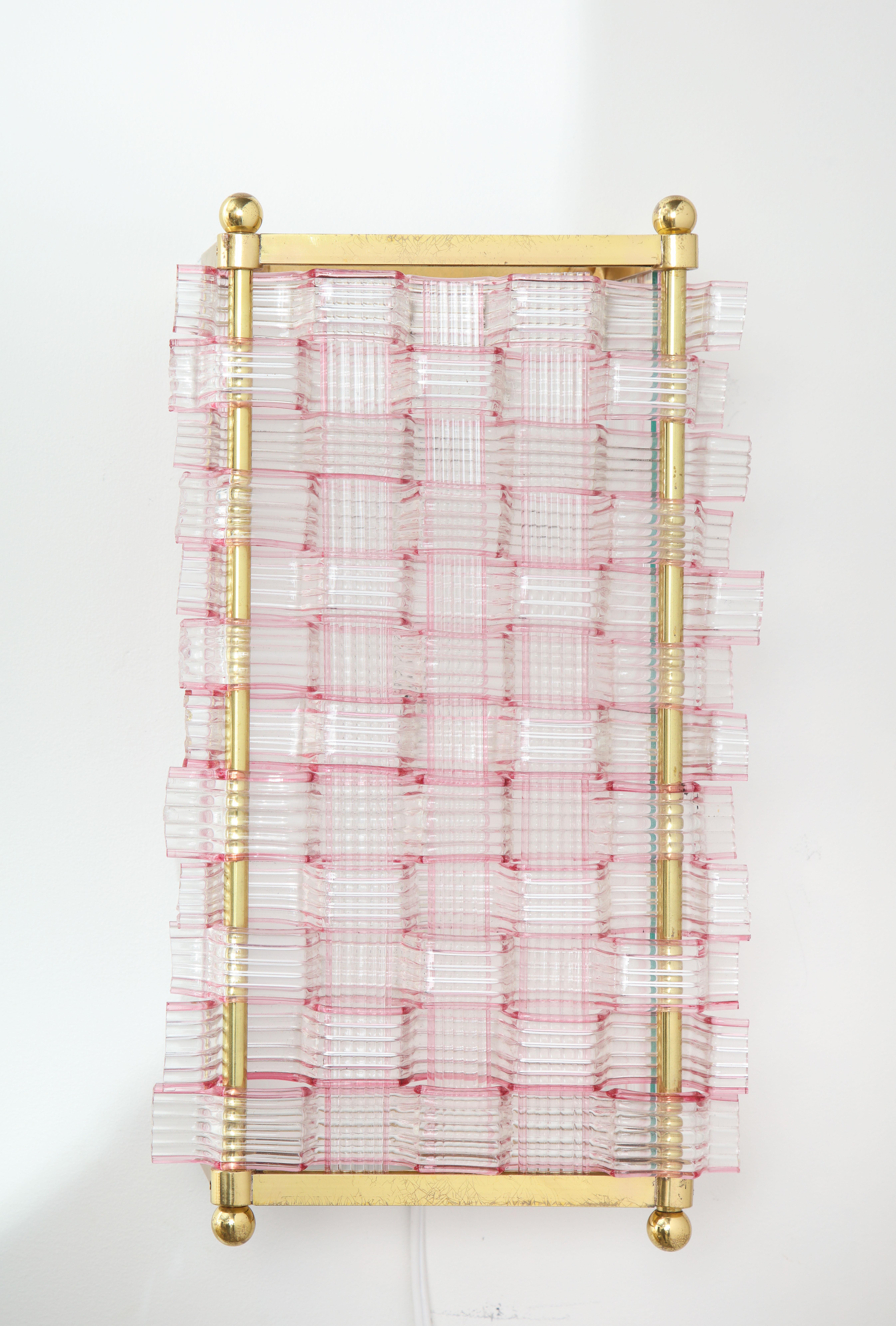 The brass cage with ribbon form glass assembled in a woven pattern on both front and sides. Interior allows for two bulbs.
  