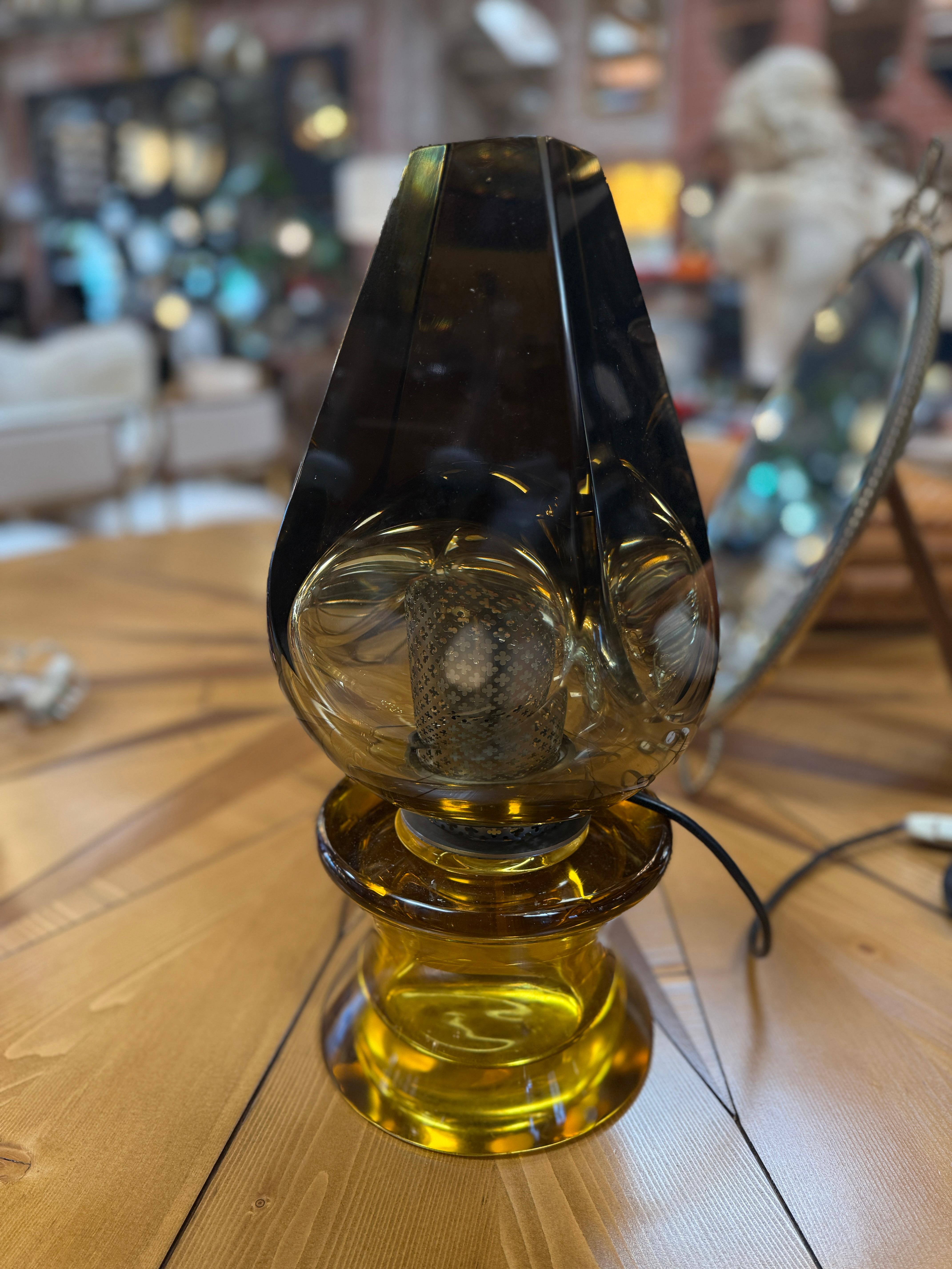 A Flavio Poli Seguso sculptural murano glass table lamp crafted in Italy during the 1970s. This striking piece features a bold teardrop silhouette in vivid green glass, masterfully hand-blown with thick, organic contours that catch and refract light