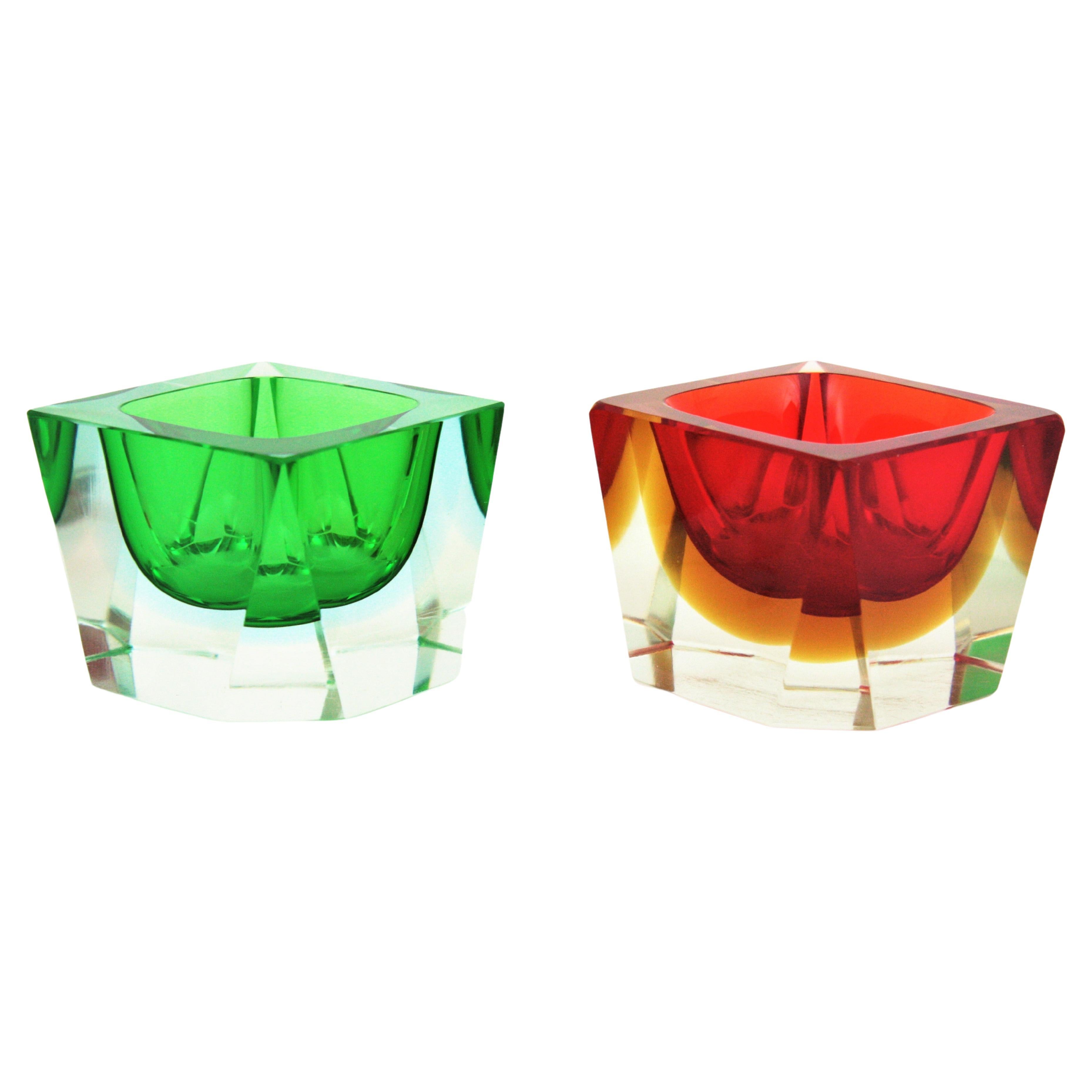 A set of two Flavio Poli for Seguso Vetri d'Arte Murano glass Sommerso bowls / ashtrays. Italy, 1960s.
One is made in red and yellow glass and other one is made in green glass, submerged into clear glass. Both have flat cut rims.
These highly