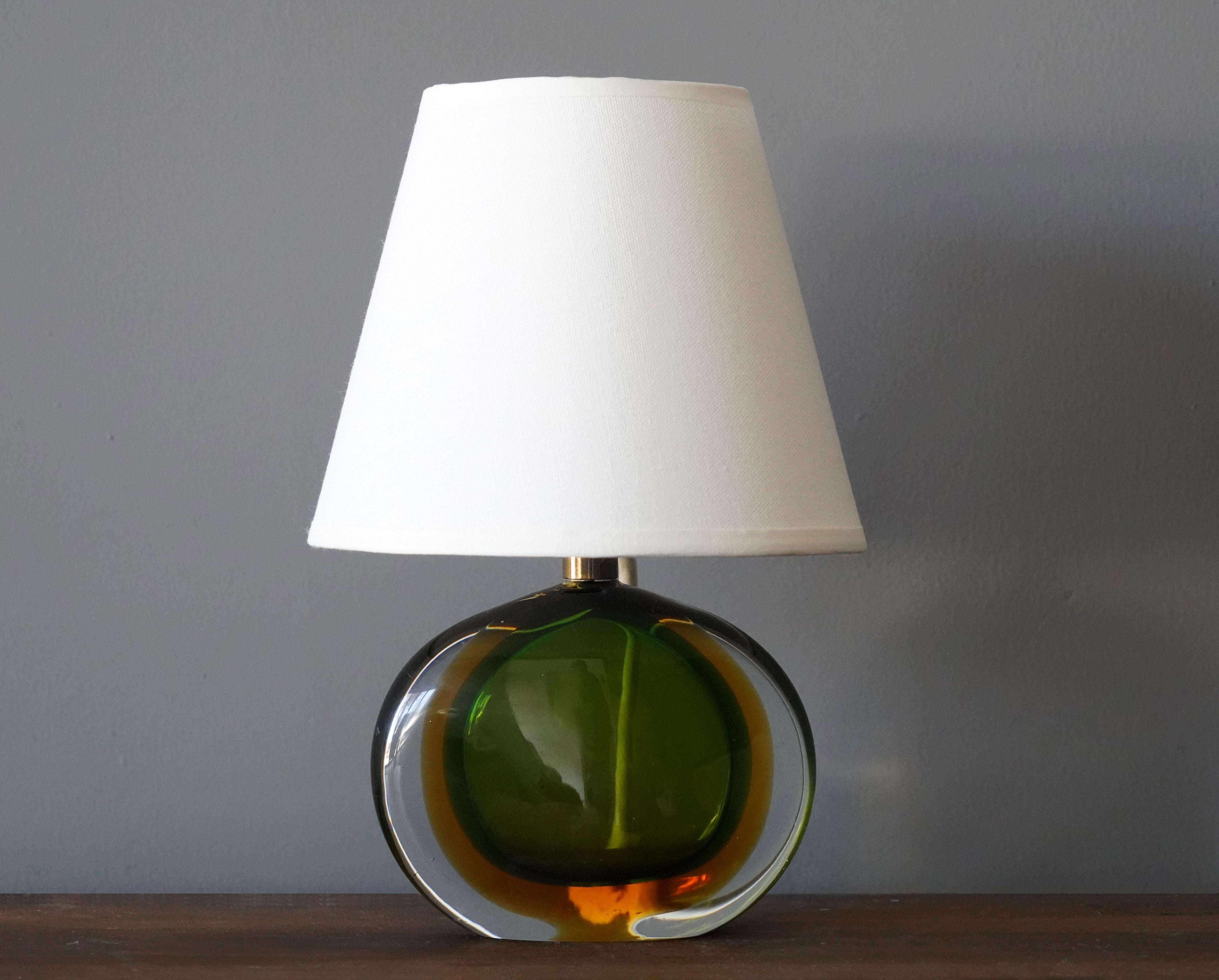 A small table lamp by Flavio Poli for Seguso. In green and orange colored Murano glass.

Other designers / makers of the period include Max Ingrand, Angelo Lelii, Josef Frank, Gino Sarfatti, and Fontana Arte.