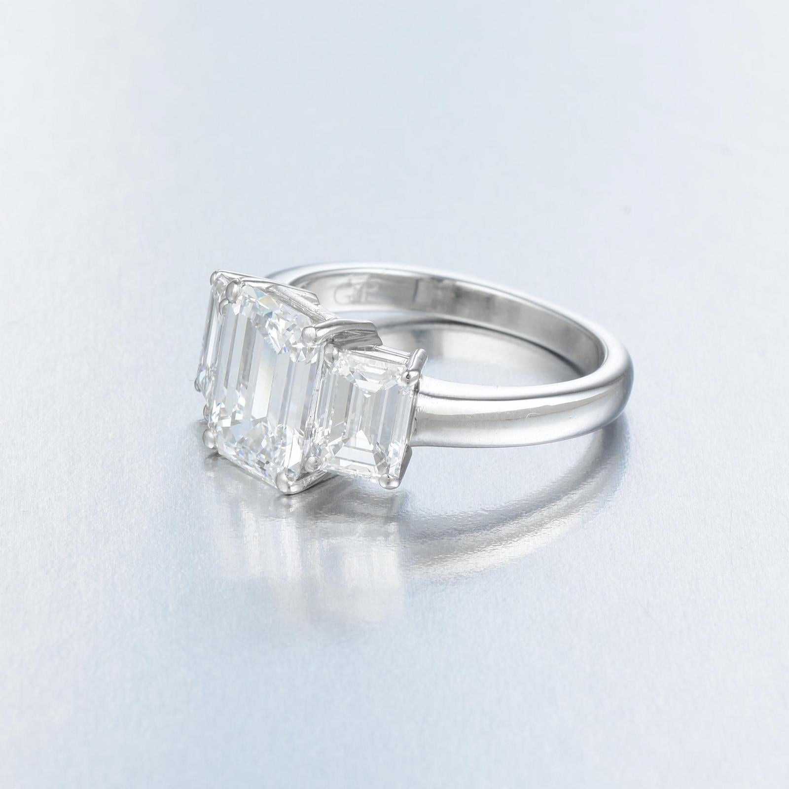 The main stone is an amazing quality Gia Certified 4 Carat Emerald Cut Diamond G Color FLAWLESS Clarity

plus 0.80 carats of both side emerald cut diamonds