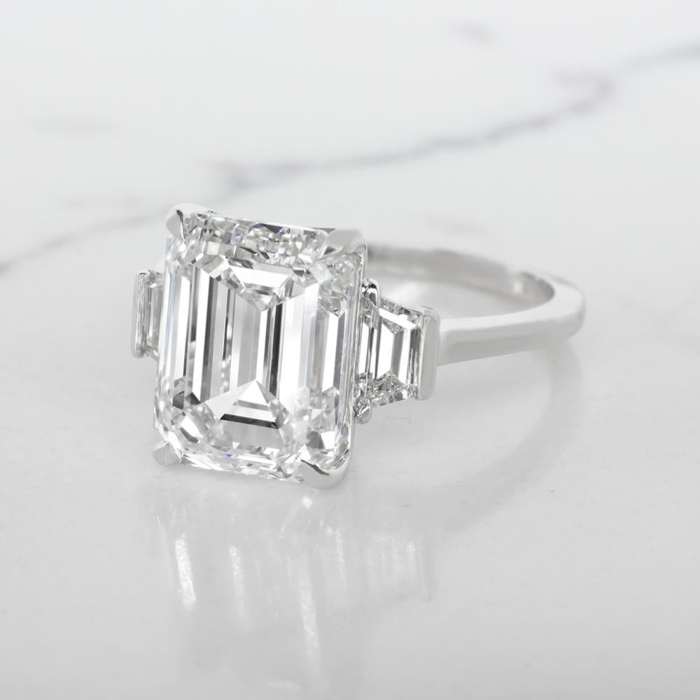 This lovely and significant ring centers on a 3.8 carat emerald-cut diamond with E rare white color and Internally Flawless clarity. The  Flawless stone is flanked by two trapezoid-cut diamonds totaling mounted in 18 carats white gold.

Internally
