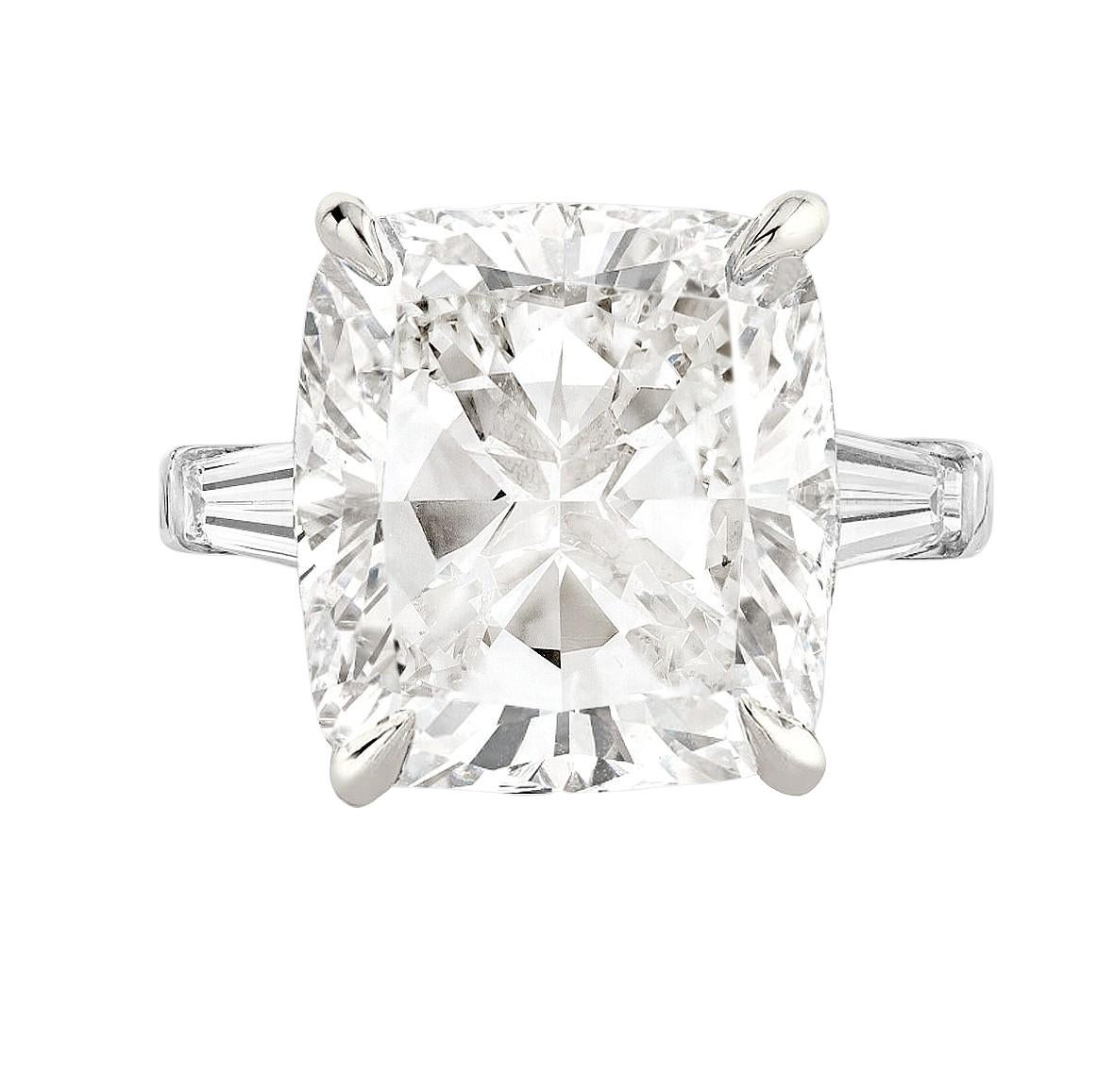 Introducing the stunning GIA Certified 4.01 Carat Cushion Cut Diamond Ring, enhanced by tapered baguette diamonds. This exquisite ring features a captivating cushion-cut diamond, certified by the renowned Gemological Institute of America (GIA) for