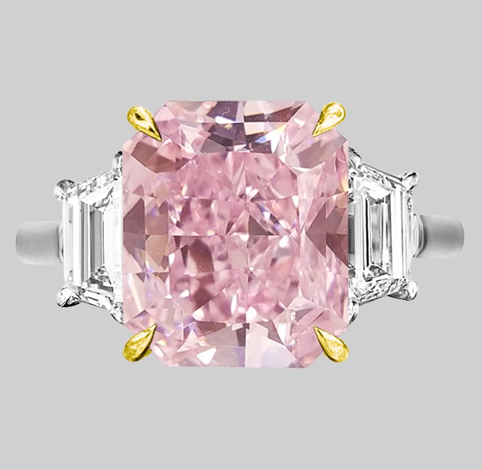 A truly remarkable piece of fine jewelry: an exquisite GIA Certified 8 Carat Fancy Brown Pink Diamond Ring, elegantly set with two trapezoids, nestled within a combination of solid platinum and 18 carats yellow gold.

This extraordinary ring