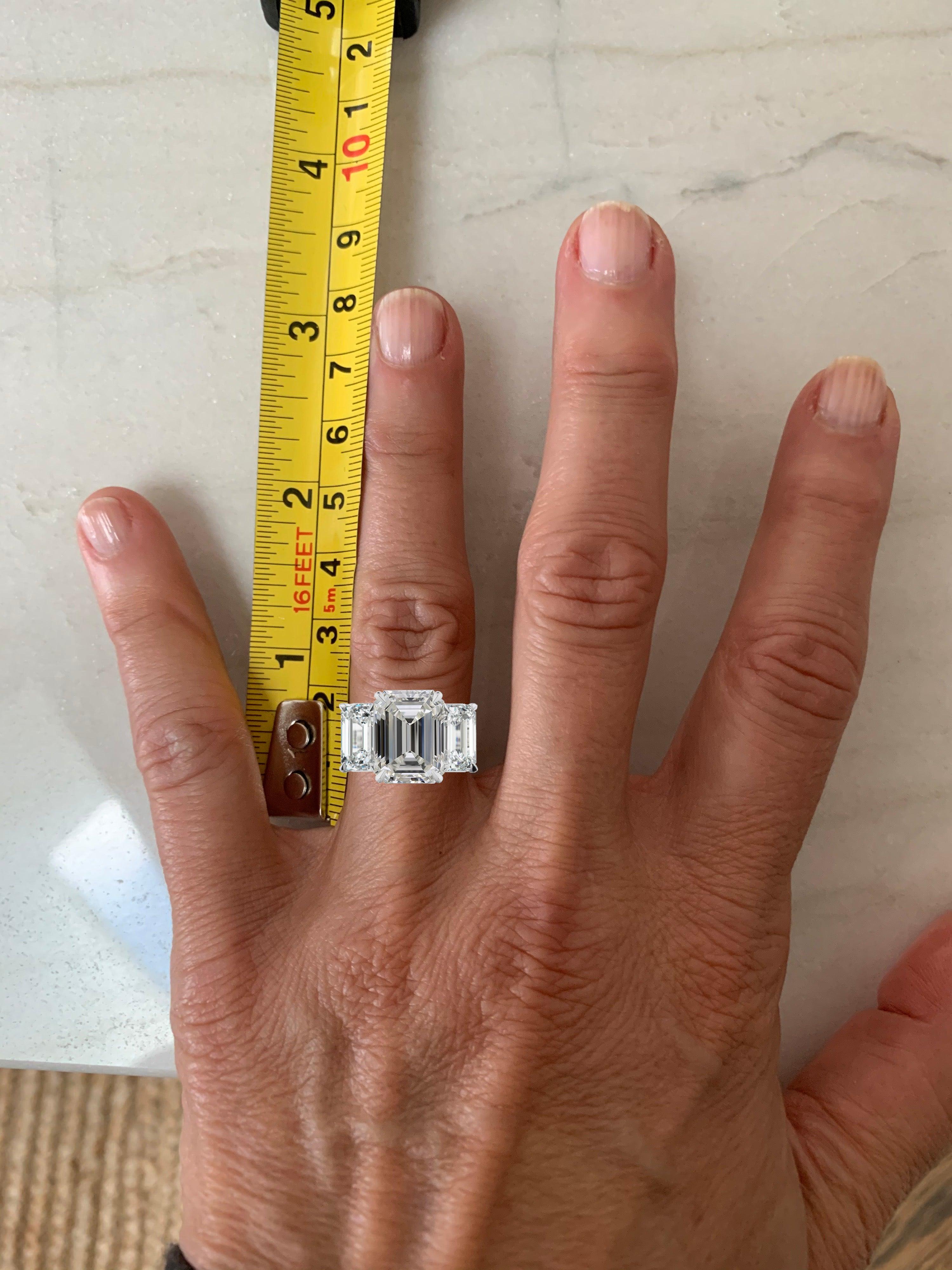 A magnificent three stone diamond ring composed by a 5.02 carat emerald cut diamond Flawless in clarity and G (rare white) Color. The side emerald cut diamonds at each side weight approximately 1 carat each and are G/F in color and VS in clarity.
