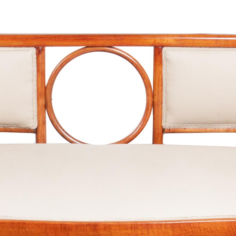 This settee is a fusion of two styles: Josef Hoffmann’s Secession and Thonet’s furniture aesthetics. It is made entirely of bent orange beechwood, varnished and polished.

Josef Hoffmann was an Austrian architect and designer, who contributed to