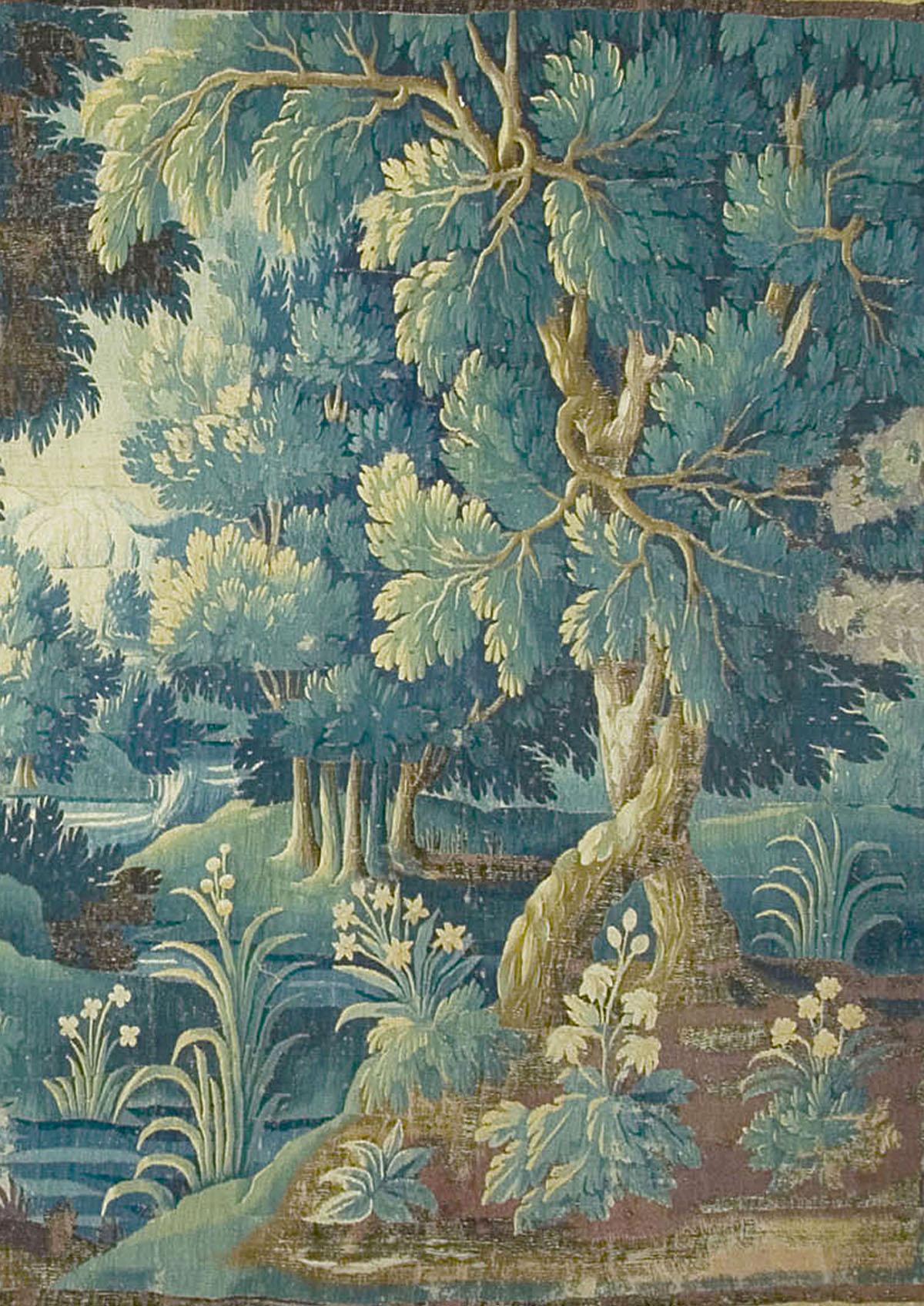Flemish 17th century Verdure tapestry. 9'2 x 15'3 wide. A beautiful summer scene of a brook in the countryside running past lush flowers and thriving wildlife. In the center an architectural stonework fountain with two regal birds perched on its