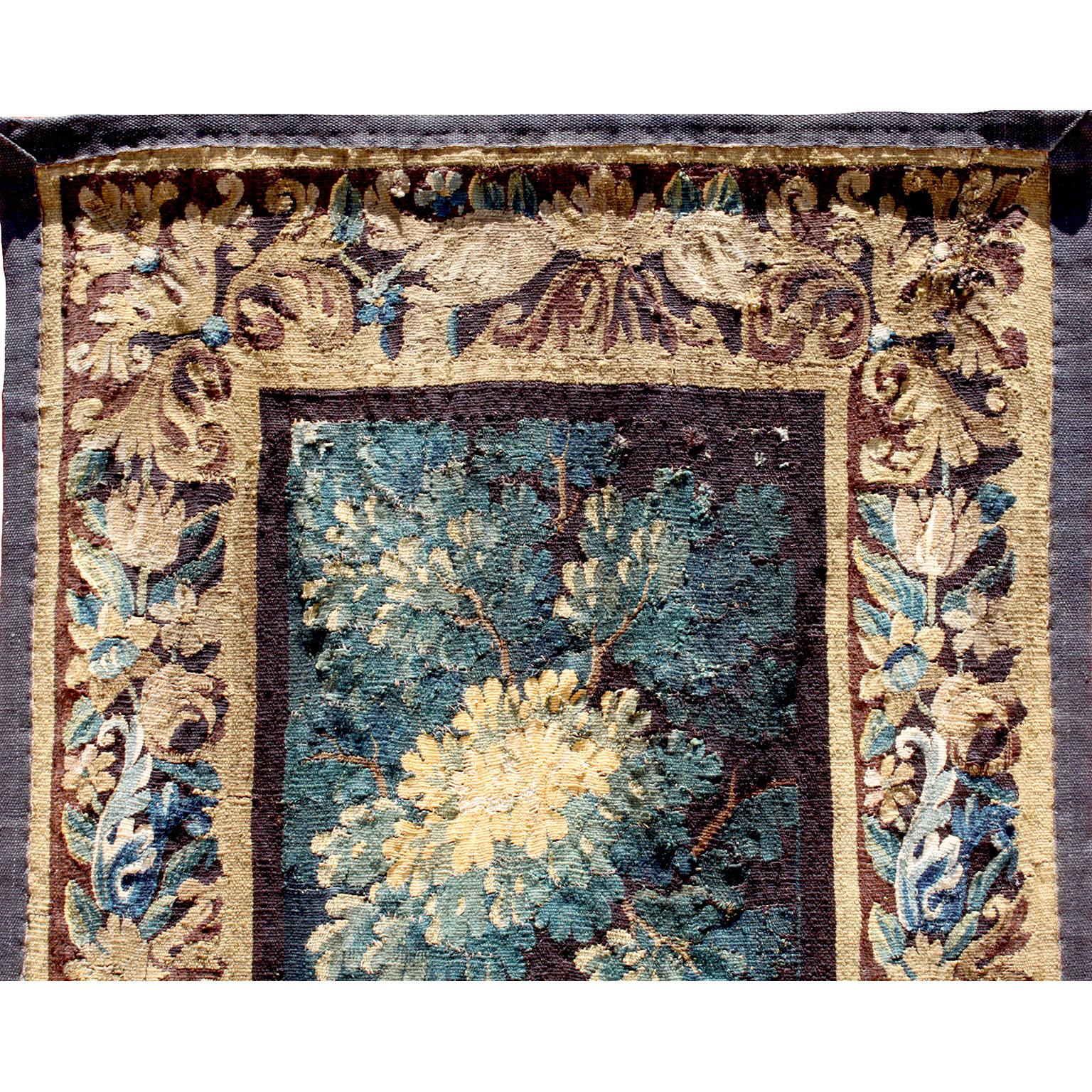 A fine flemish 18th-19th century Verdure landscape tapestry, the wool and silk tapestry centered by a scene of a tall tree within a forest background and a foliage border. Circa: 1800.

Measures: Height: 100 1/4 inches (254.6 cm)
Width: 37 1/4