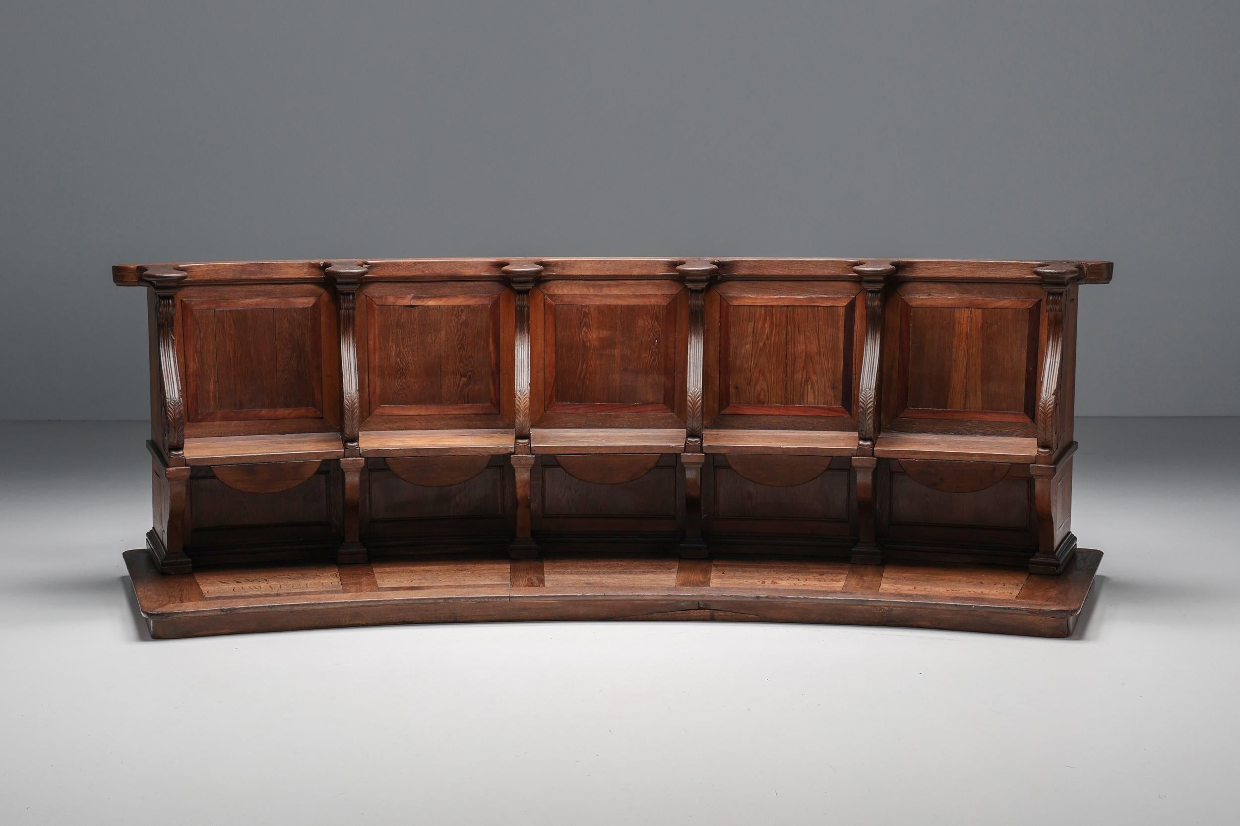Flemish 18th century church pew, crafted from thick and solid oak wood. A remarkable and unusual piece, featuring curved sides and carved details. Originally, these pieces were used as real church pews, which gives them a historic value and feel.