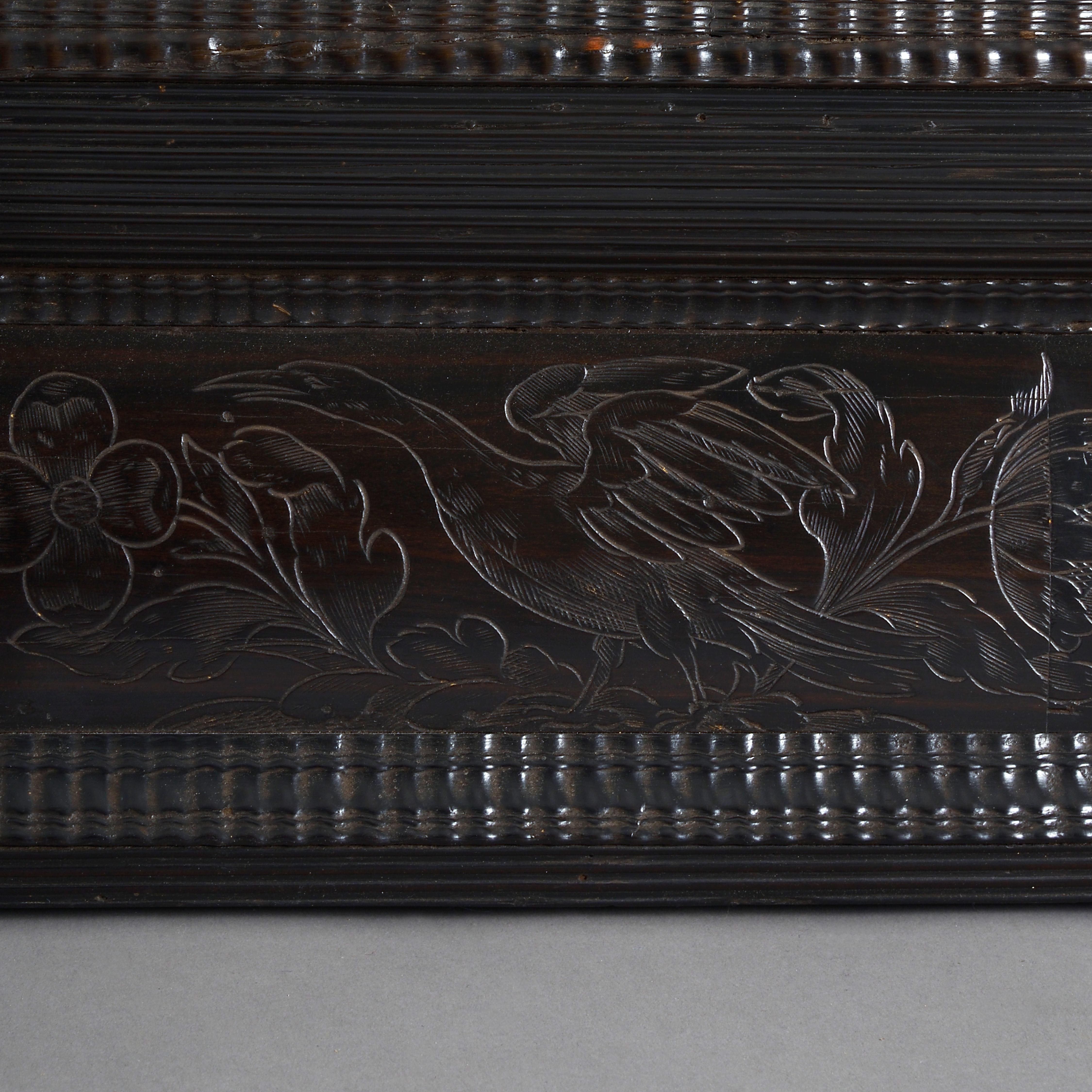 A Flemish Baroque ebony mirror, late 17th century.

The ripple-moulded cushion frame engraved with flowers and birds.