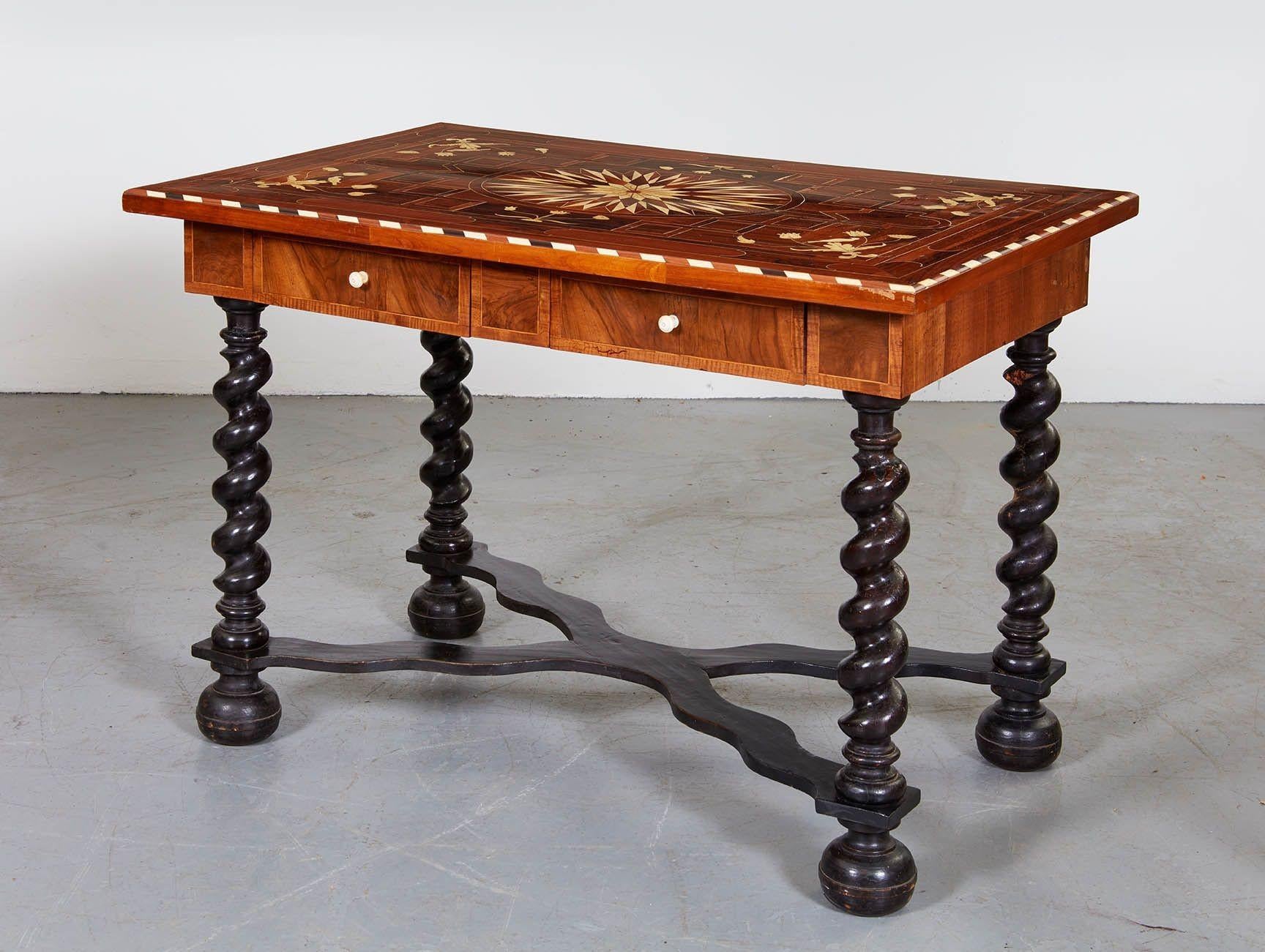 Good 19th Century Flemish baroque bone inlaid rosewood, walnut and ebonized wood center table, the top with inlaid starburst on a geometric marquetry ground, the corners inlaid with flowering urns with birds on the branches, over single drawer with