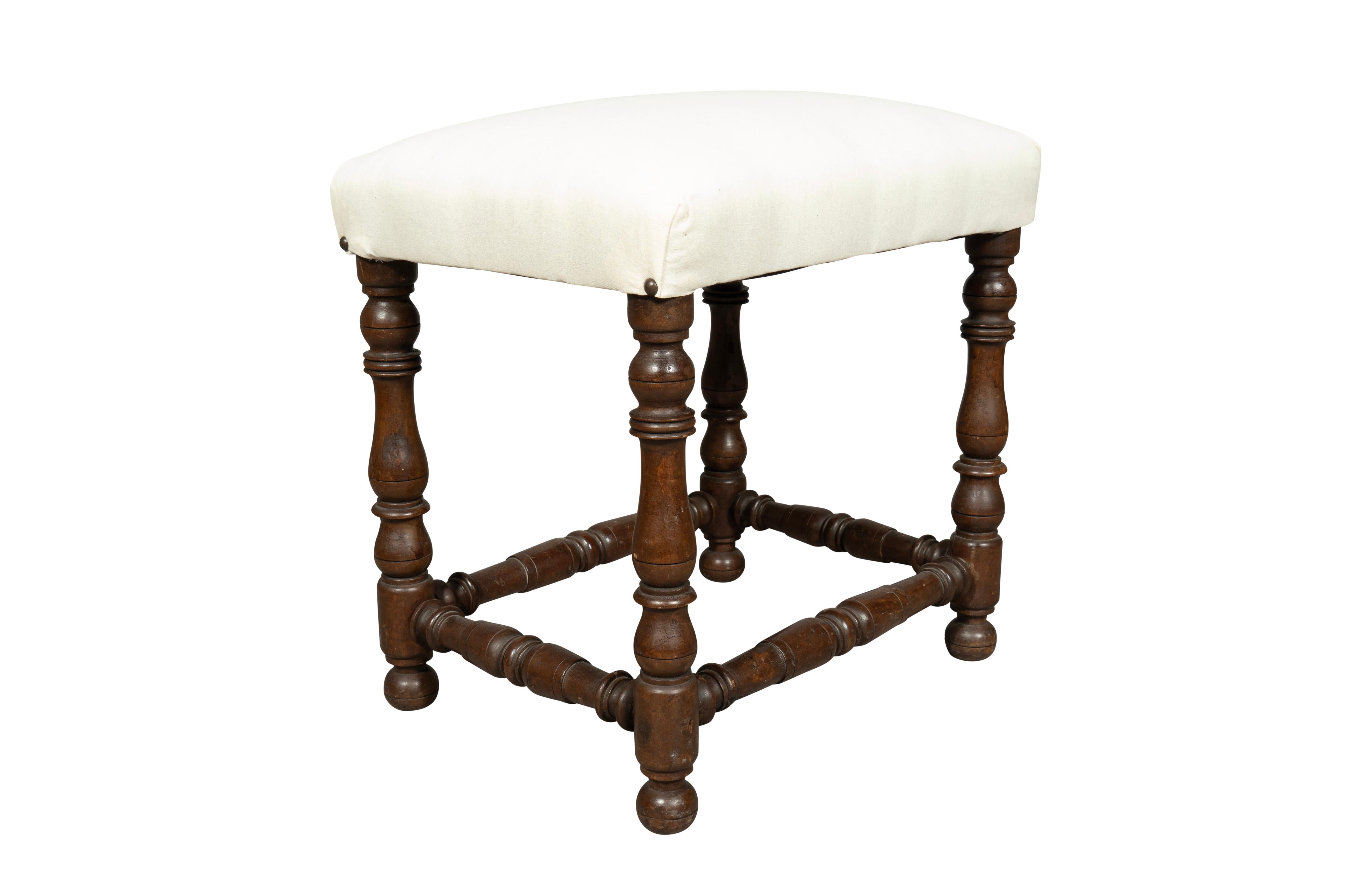 Newly upholstered in muslin. Turned legs and stretchers.