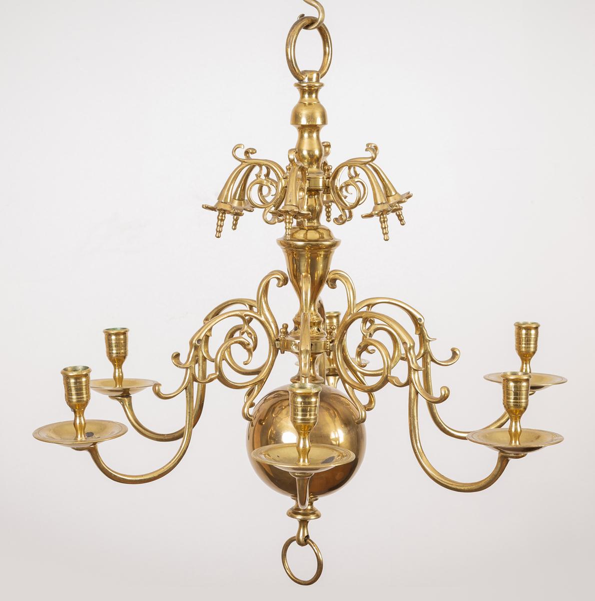 A classic Flemish brass six scrolled arm chandelier with two tiers issuing from the elegant central vase stem, the upper tier decorated with stylized flowers. At the moment this chandelier is for candle use, but can easily be wired for electricity.