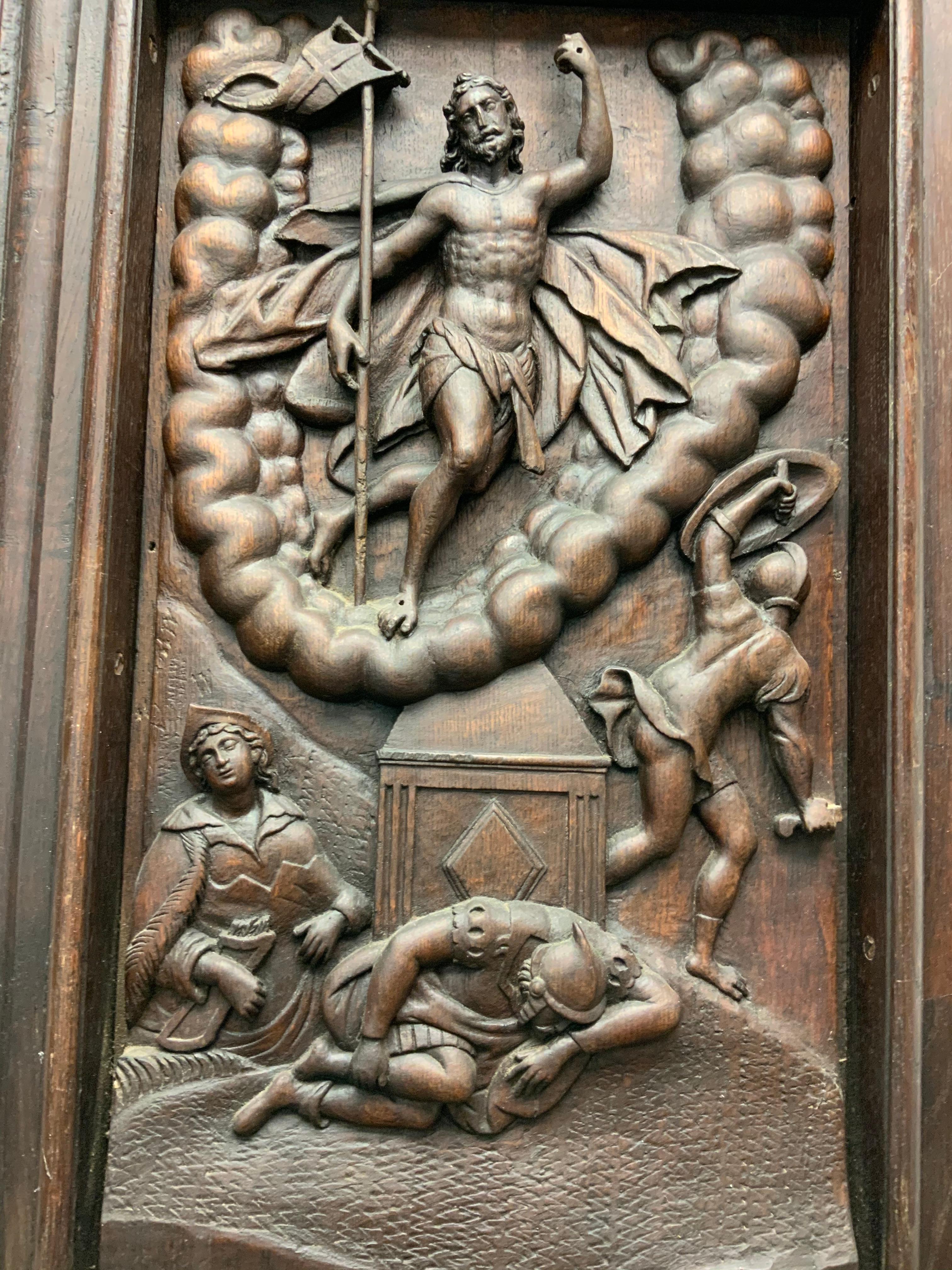 This is a heavy large carved wood plaque depicting an embossed scene of the Resurrection of Jesus Christ. He is standing victorious and elevated over a U shaped cluster of clouds with the banner of Resurrection in his right hand. The left arm is