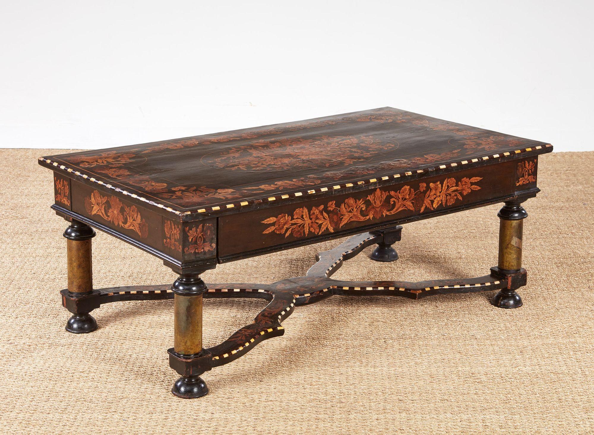 Very fine 19th century Flemish ebony coffee table having floral marquetry inlay inlaid bone designs on a walnut, ebony and faux tortoise background, bone and ebony patterned moldings, with single long drawer, the legs copper clad and joined by a