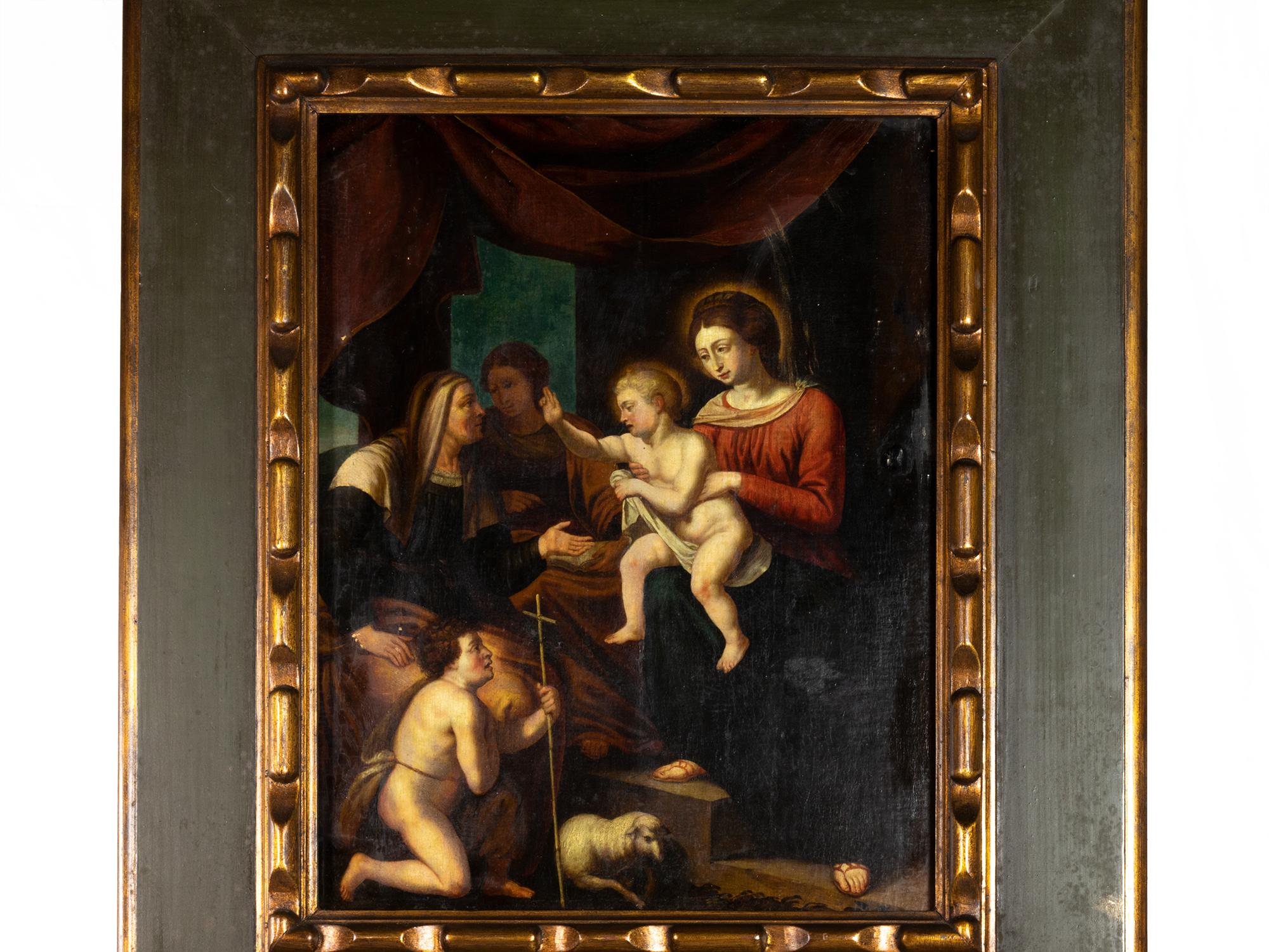 This 18th-century Flemish oil on wood painting depicts the moment of adoration of the Child Jesus, in the loving arms of the Virgin Mary. 
Kneeling at their feet is the young Saint John the Baptist, recognizable by his humble cross and accompanied