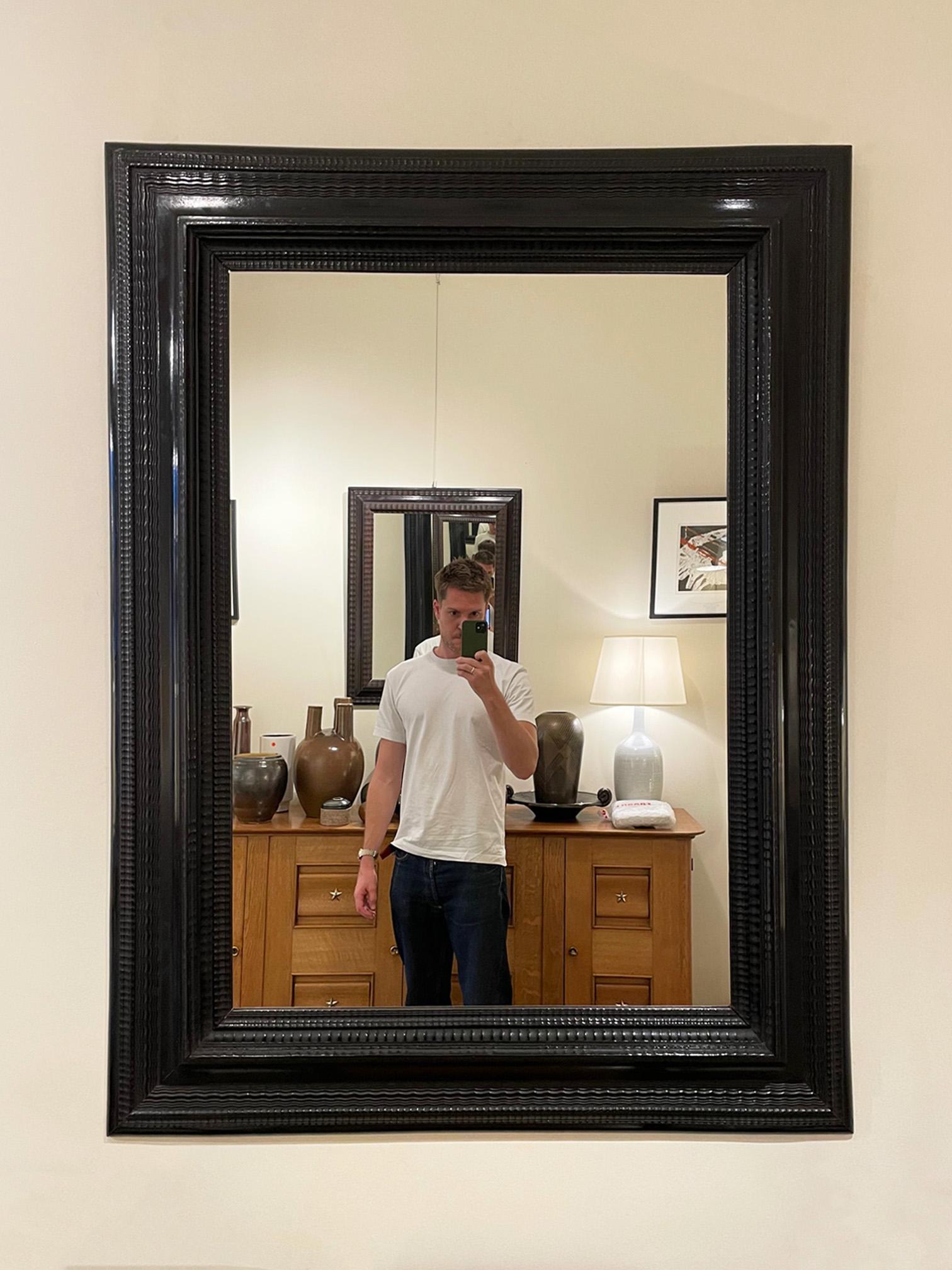 A large Flemish style ebonised ripple frame mirror.
Italy, early 20th Century.
 