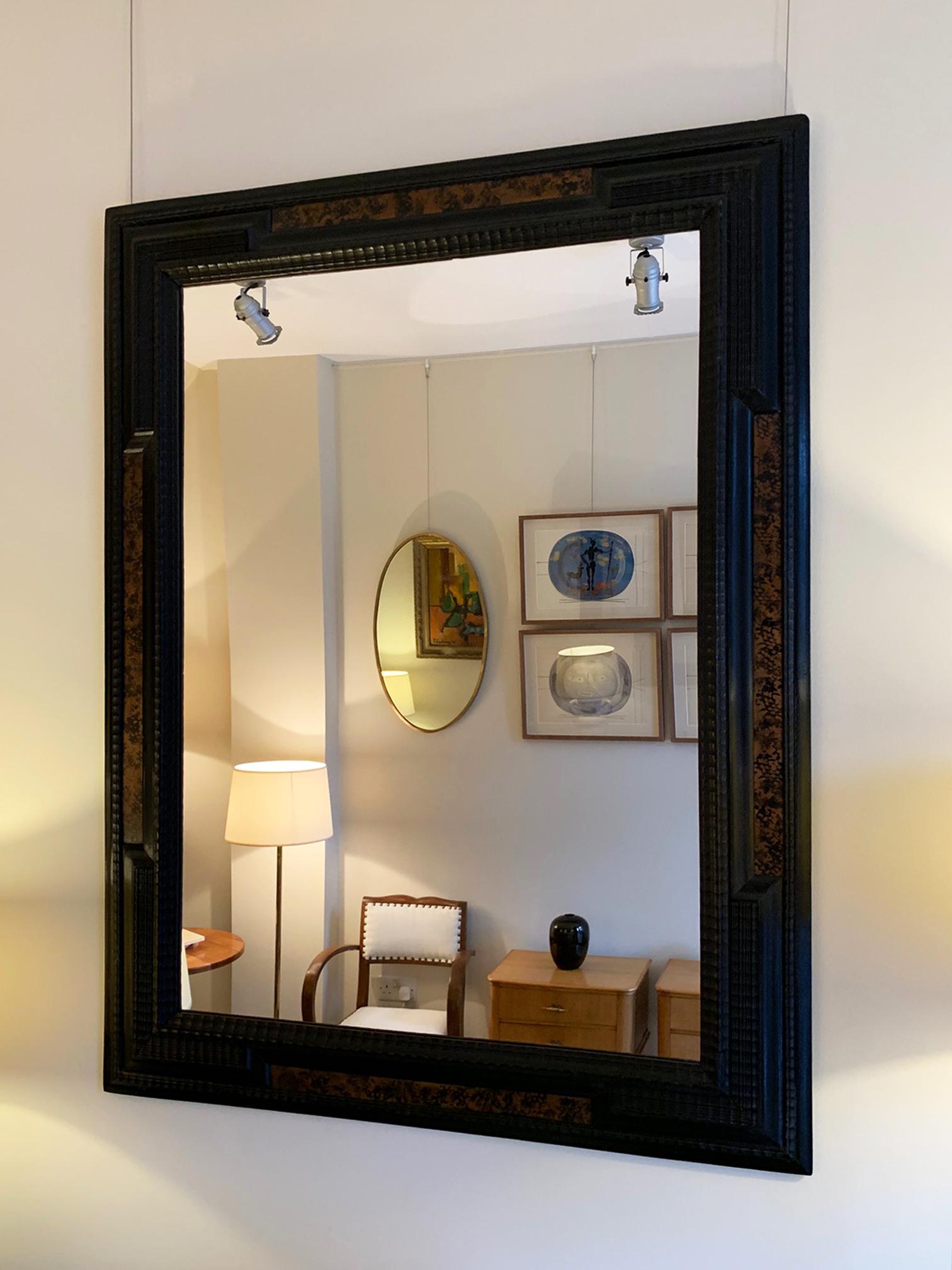 A Flemish style mirror, with faux tortoishell and carved and ebonized beech ripple frame.
Holland, early 20th century.
  