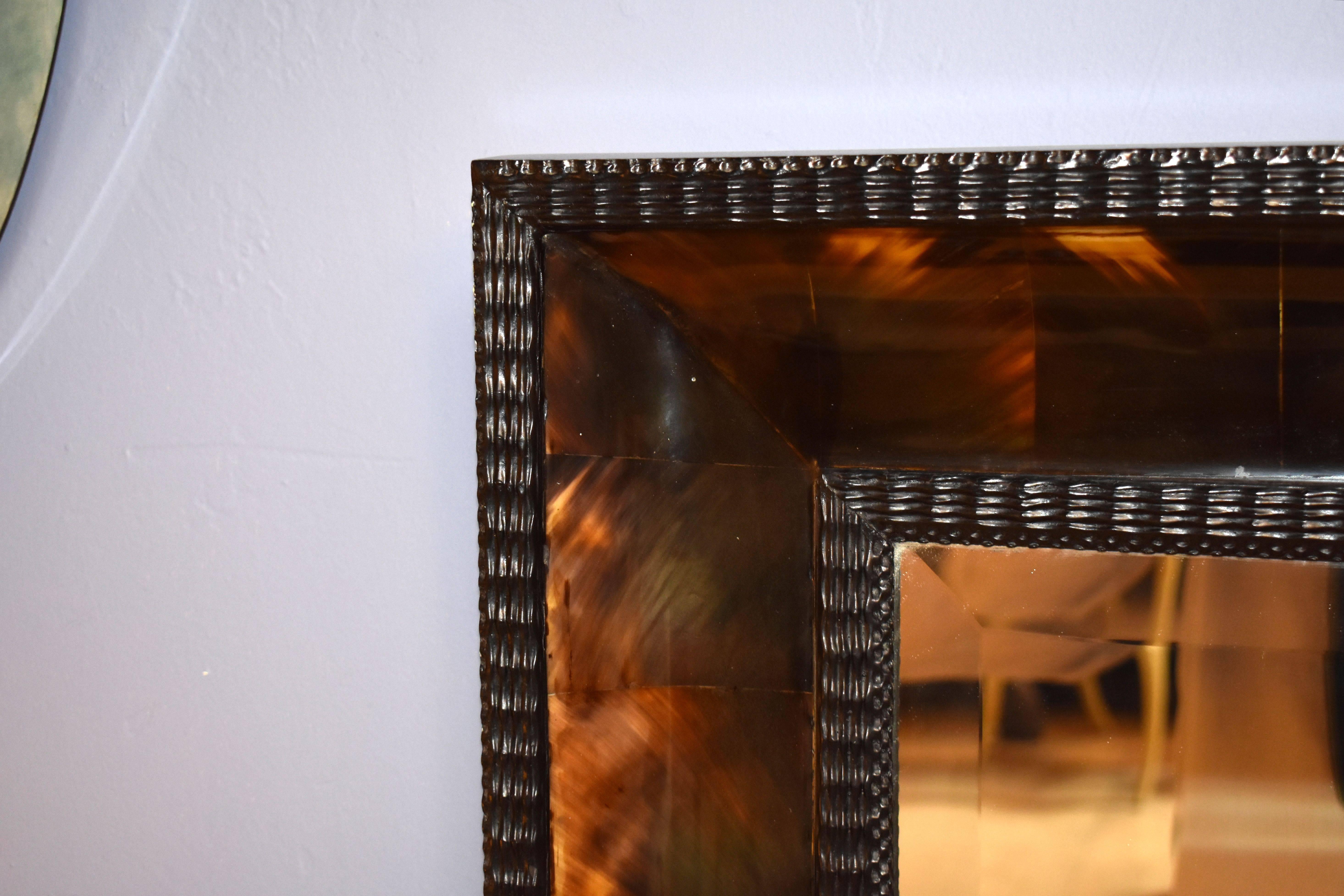 Ebonized frame cover with horn and beveled mirror.