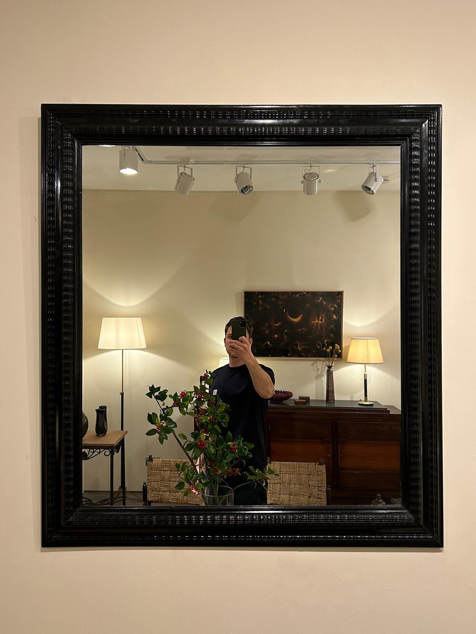 A Flemish style ebonised ripple frame mirror
Italy, mid 20th Century.
New mirror plate.
109.5 cm high by 100 cm wide by 6 cm deep