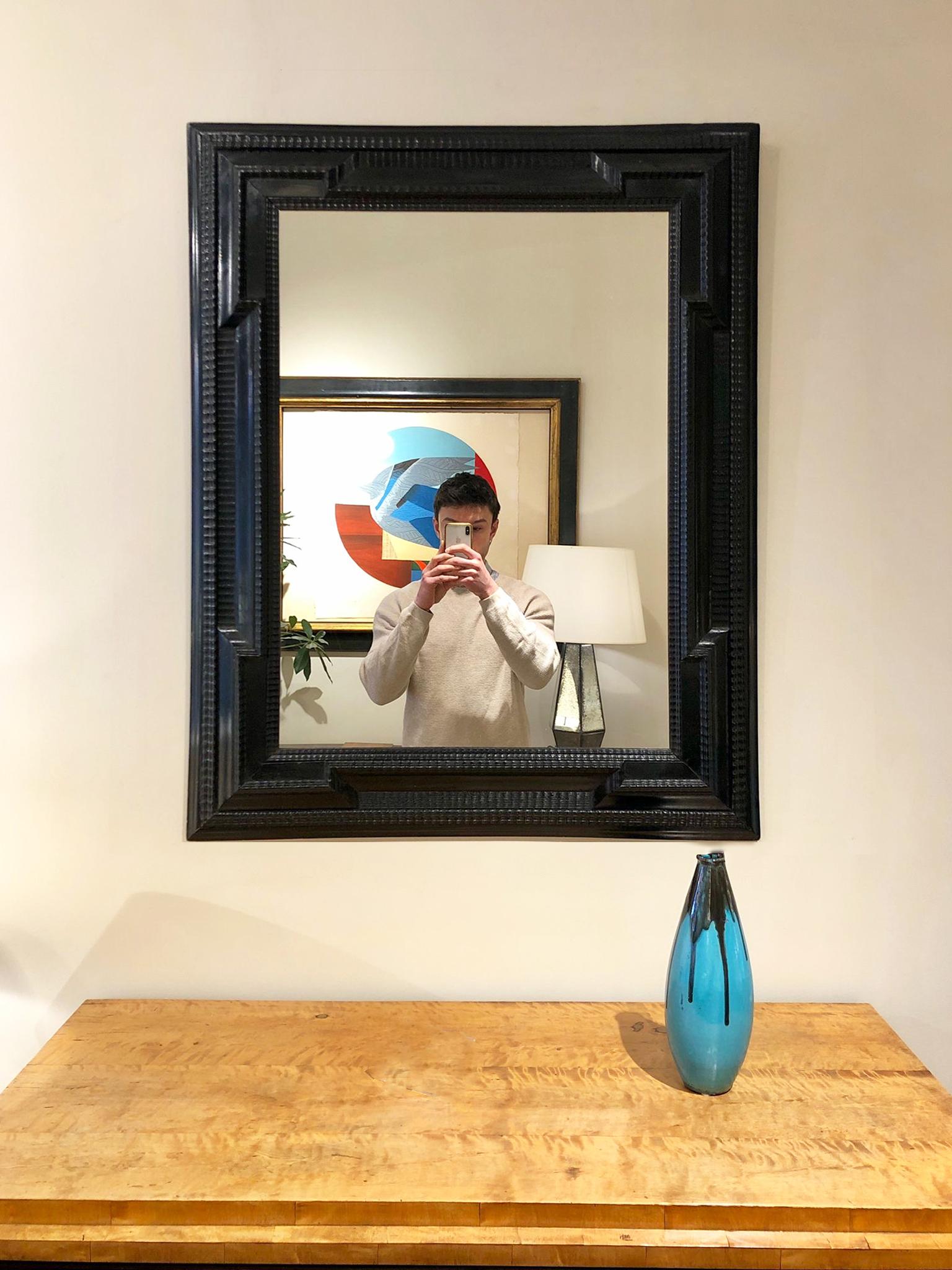 A Flemish style ebonised ripple frame mirror
Italy, early to mid 20th Century
New mirror glass
