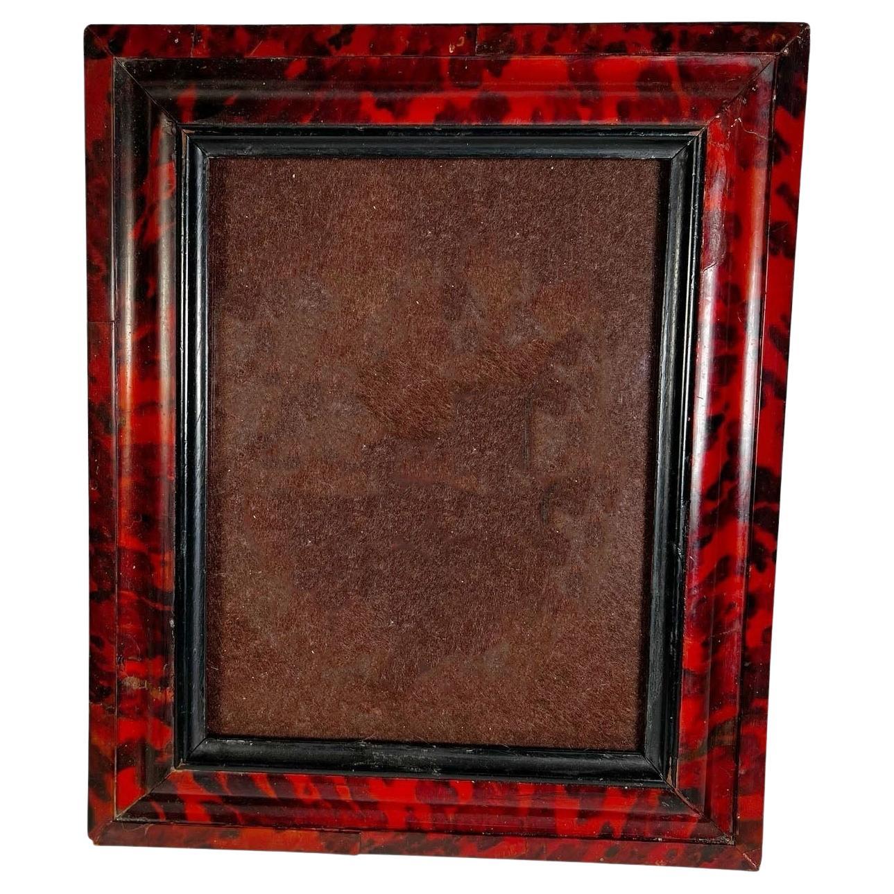 A striking and rare Flemish frame dating from circa 1800–1820, crafted in genuine tortoiseshell with richly saturated red and black coloring. The natural marbling of the shell gives the surface a glowing, almost lacquered depth, a hallmark of luxury