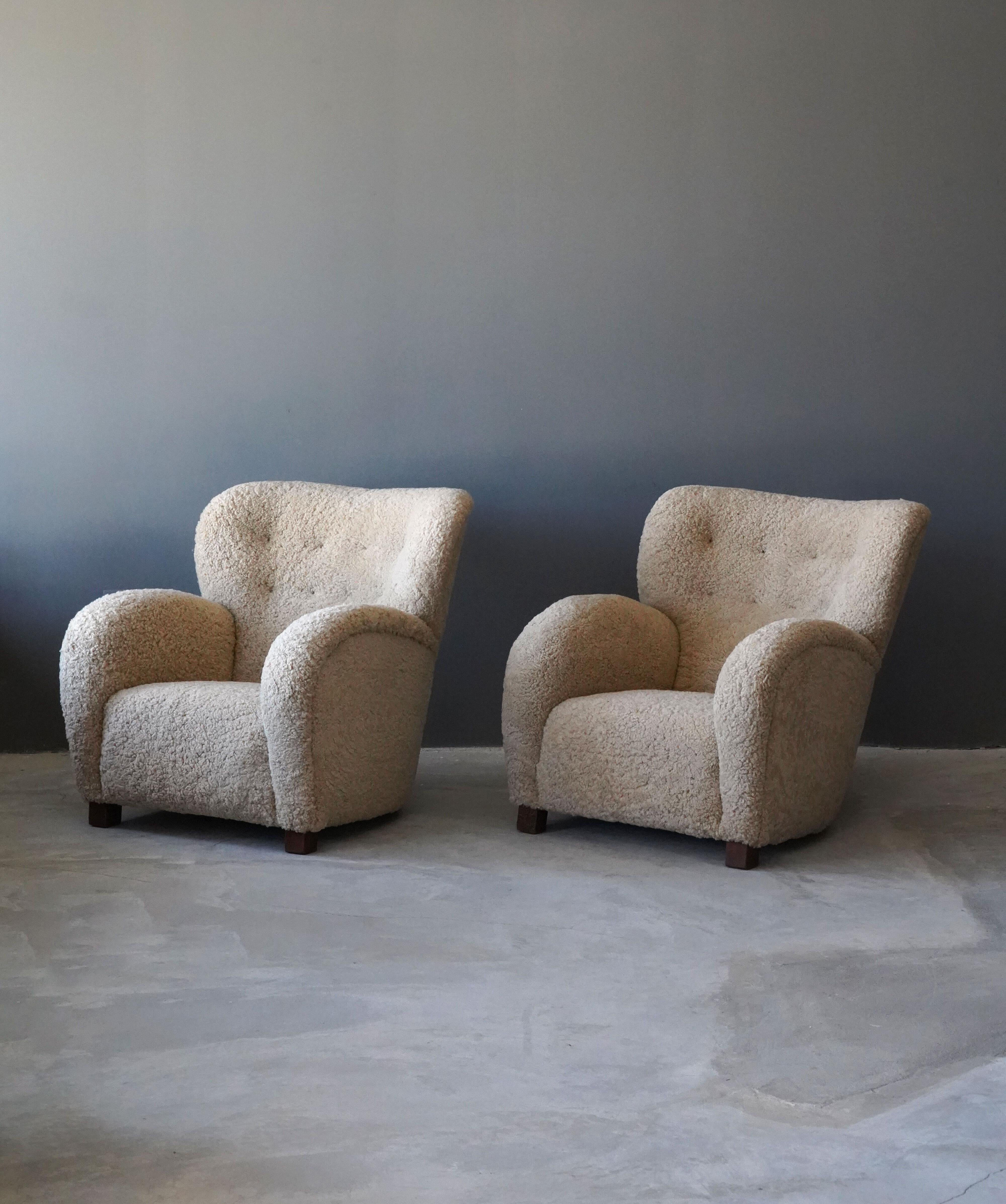 Two organic lounge chairs. Design attributed to Flemming Lassen. The chairs organic form is further enhanced by sheepskin upholstery. 

Other designers of the period include Gio Ponti, Märta Blomstedt, Vladimir Kagan, Jean Royère, and Arnold