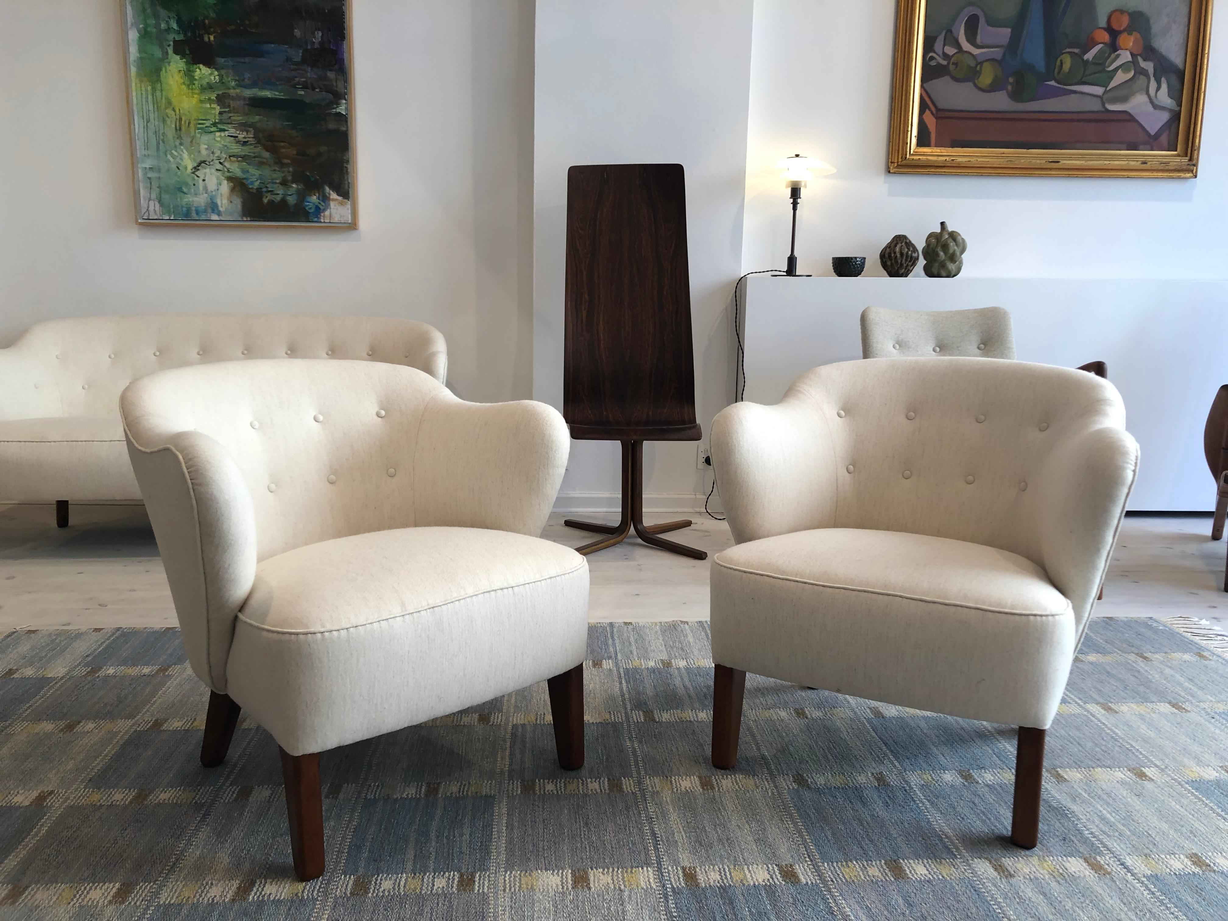 Flemming Lassen, pair of easy chairs for master cabinetmaker Jacob Kjaer, Denmark. Tapering legs in stained ash and reupholstered in white Savak fabric by Tove Kindt-Larsen.

The model was presented at The Copenhagen Cabinetmakers' Guild