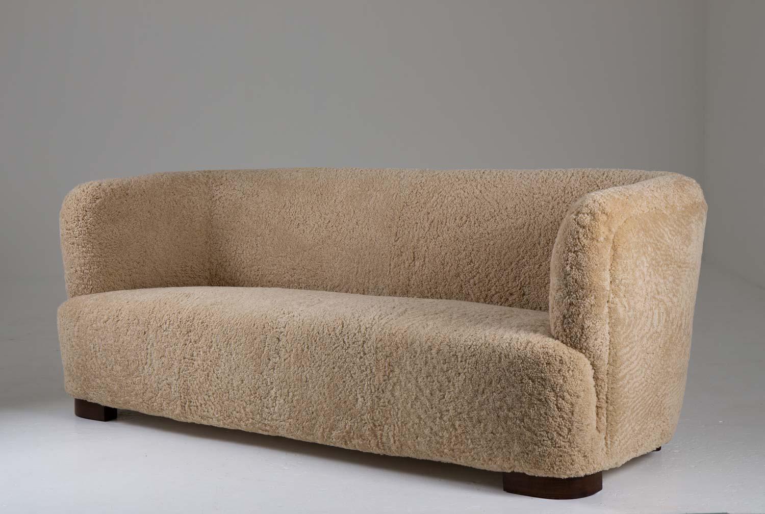 Stunning 3-seater sofa in the style of Flemming Lassen, manufactured in Denmark, 1930s. 
This organically-shaped sofa is constructed with a very high sense of quality. The proportions are absolutely great with the soft, round shapes and low