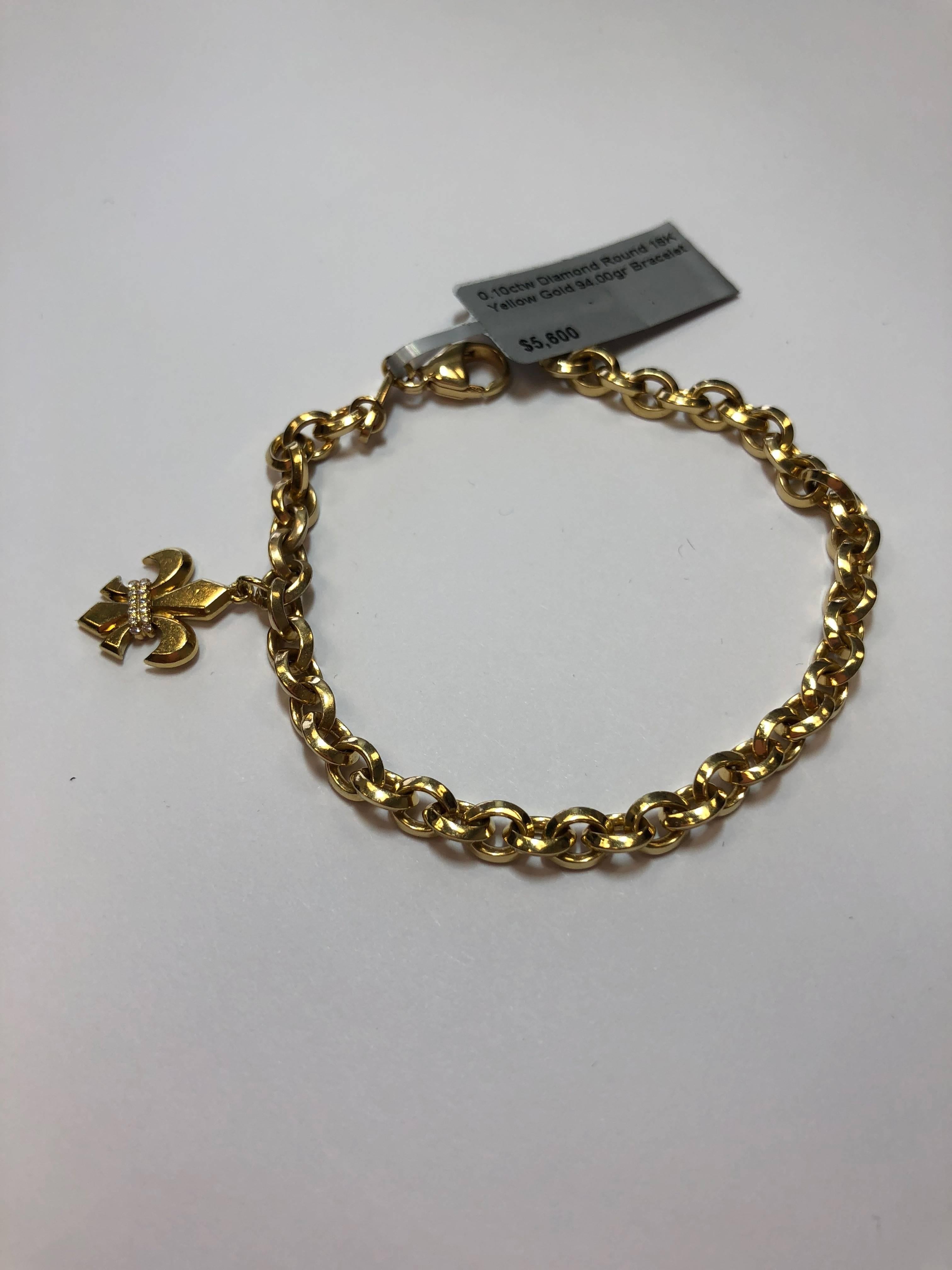 0.10 carats of white diamonds in this fleur de lis 18k yellow gold charm bracelet.  This bracelet is the perfect mix of trendy and classic.  Perfect to stack with other bracelets or a watch or wear on it's own.  