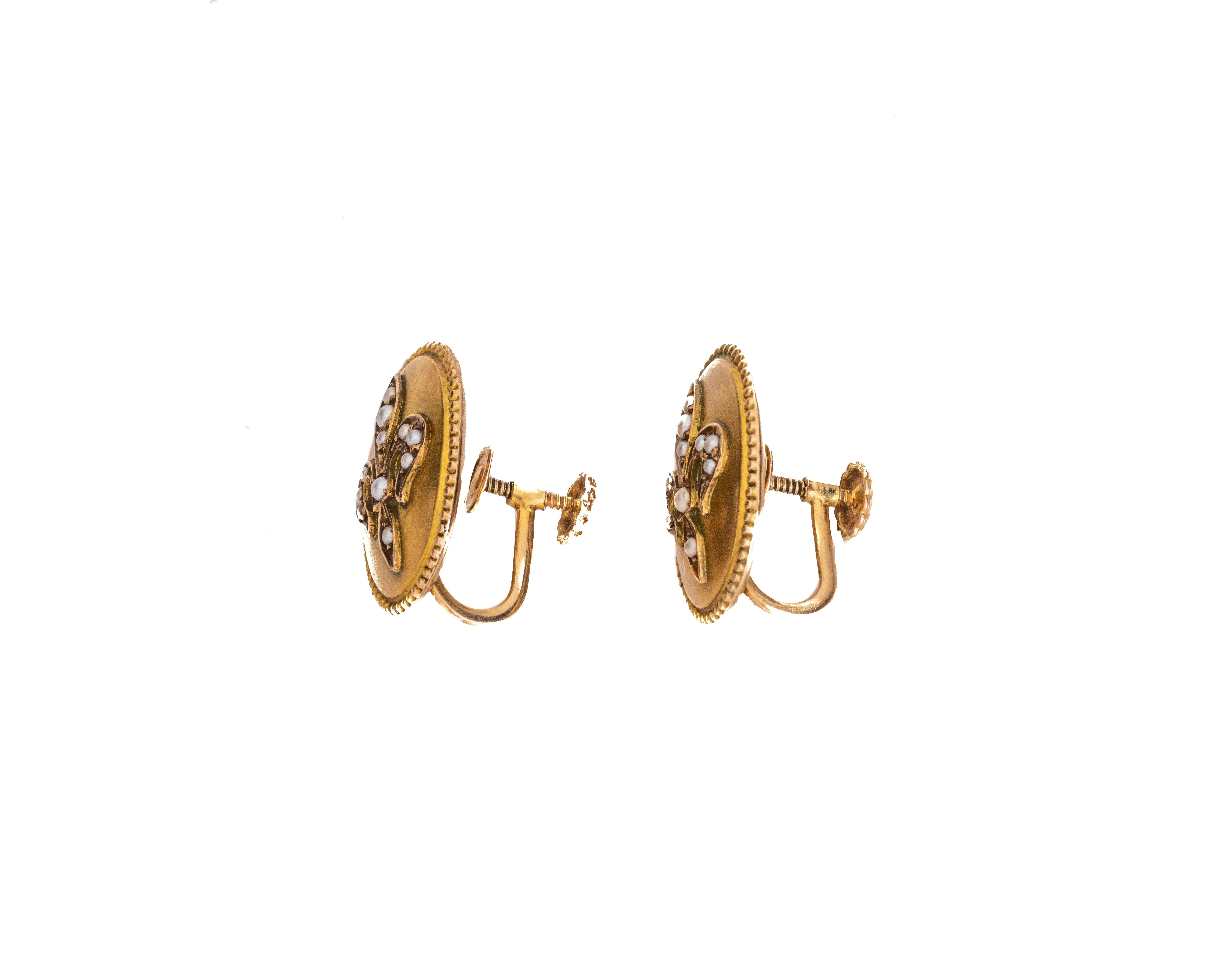 Earring Details:
Metal type: 14 karat Yellow Gold
Weight: 4 grams
Measures approximately 1 Inch in Height, Oval Shape

Features pearls in the fleur-de-lis design and a beautiful milgrain design border on the outer edge of the earrings. They are