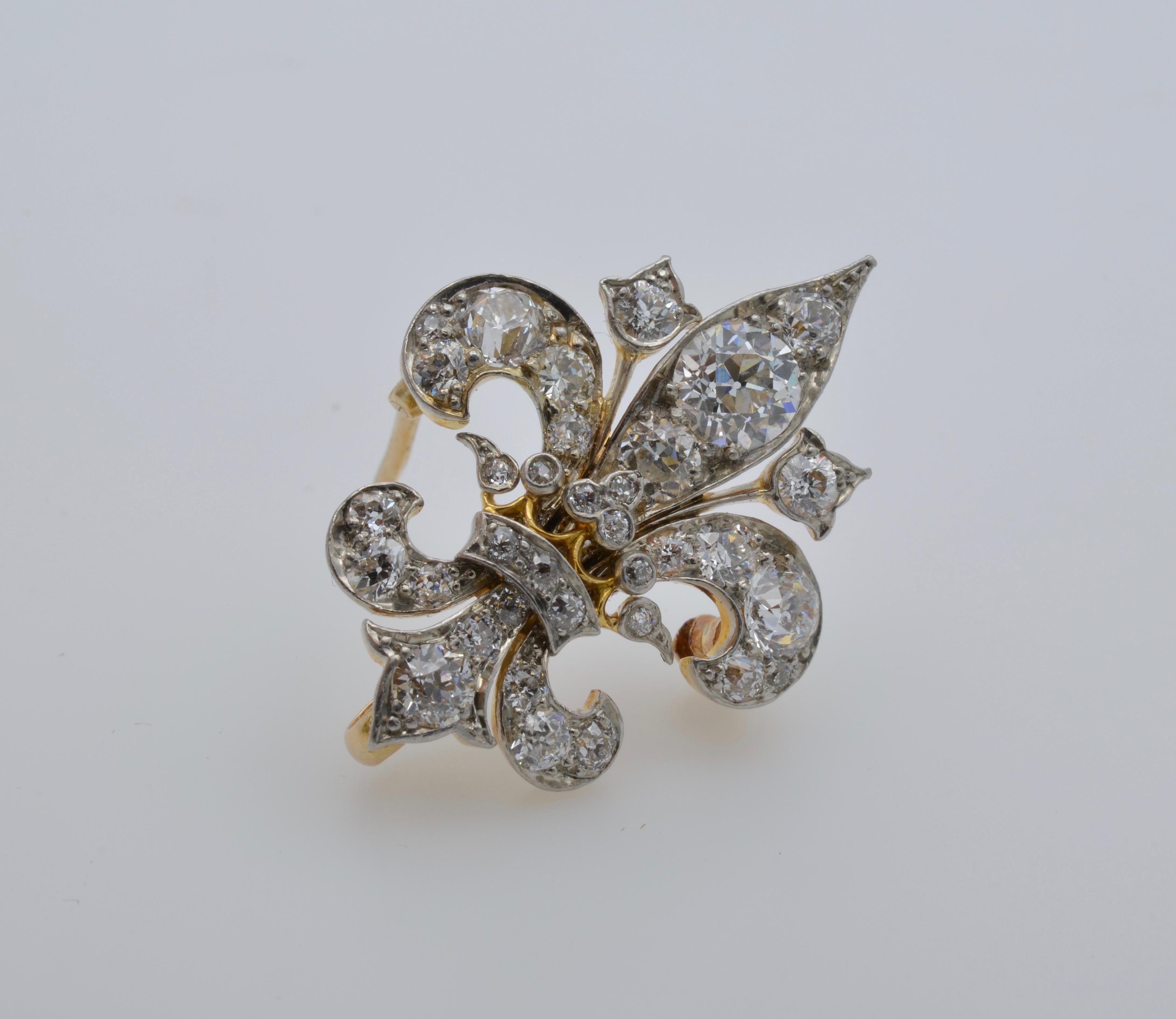 This substantial old mine cut diamond fleur de lys brooch is set in gold and made by Fraser America.
The total weight of the diamonds are approximately 1.50 carats and the quality is GH/VS2- 1 of the diamonds is a SI2.
This Brooch has a loop in the