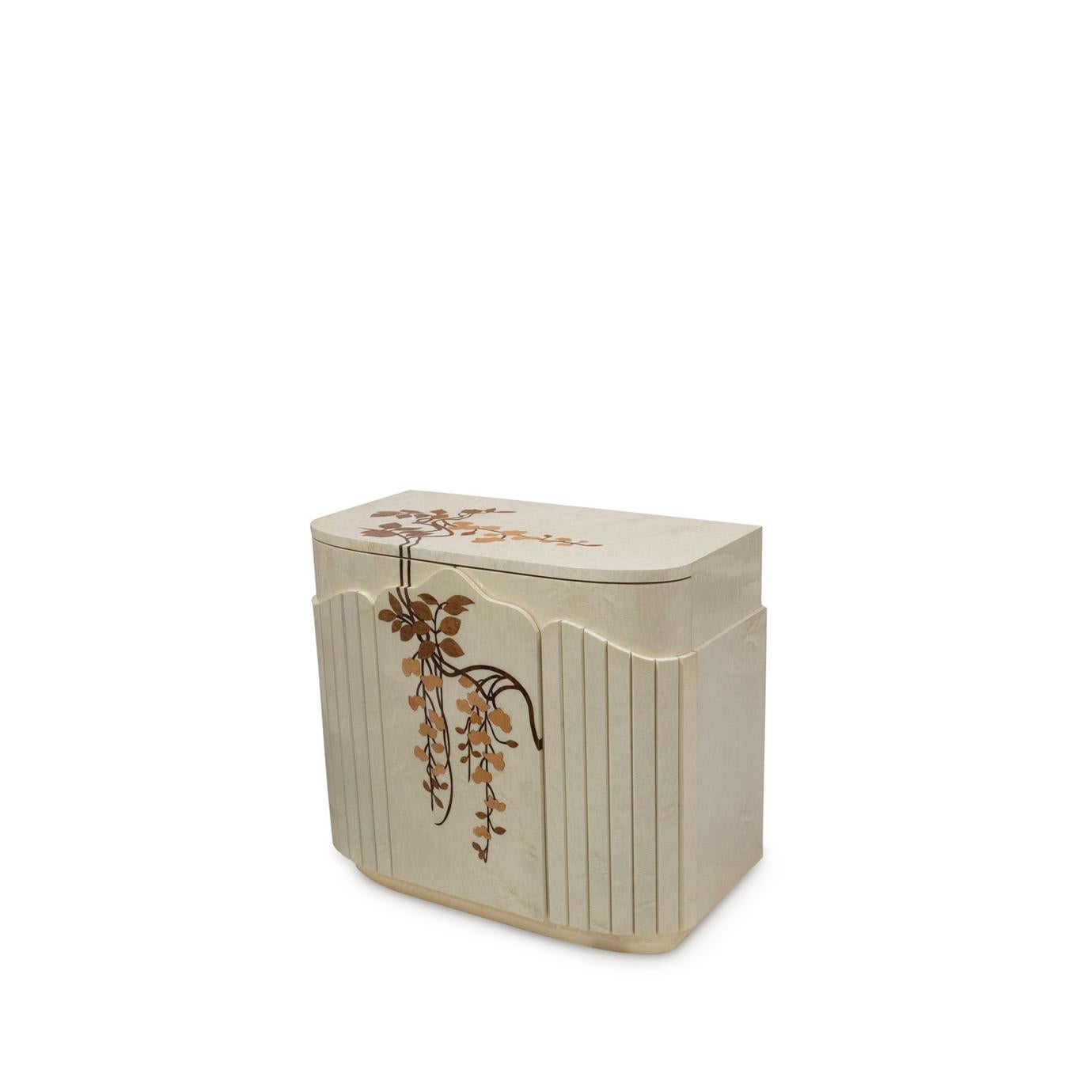 With its oval body, architectural details, sheen lacquered finish and whimsical stylized floral marquetry the Fleur Nightstand's charm is sure to add glamour to the bedroom. Each flower is cut by hand from thin sheets of wood veneer. The delicate