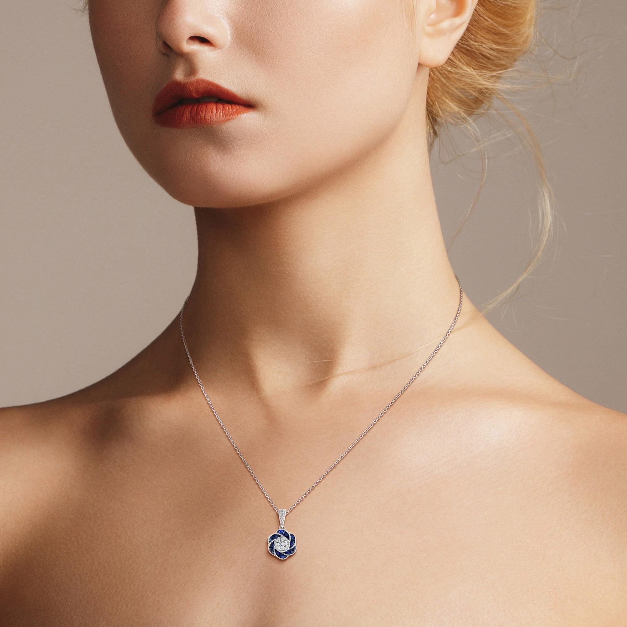 Perfect with everyday wear, this charming vintage Art Deco revivalist design pendant features brilliant-cut diamonds surrounded by bright blue sapphire for rose petals finished look all in 18K white gold.

Information
Style: Art-deco
Metal: 18K