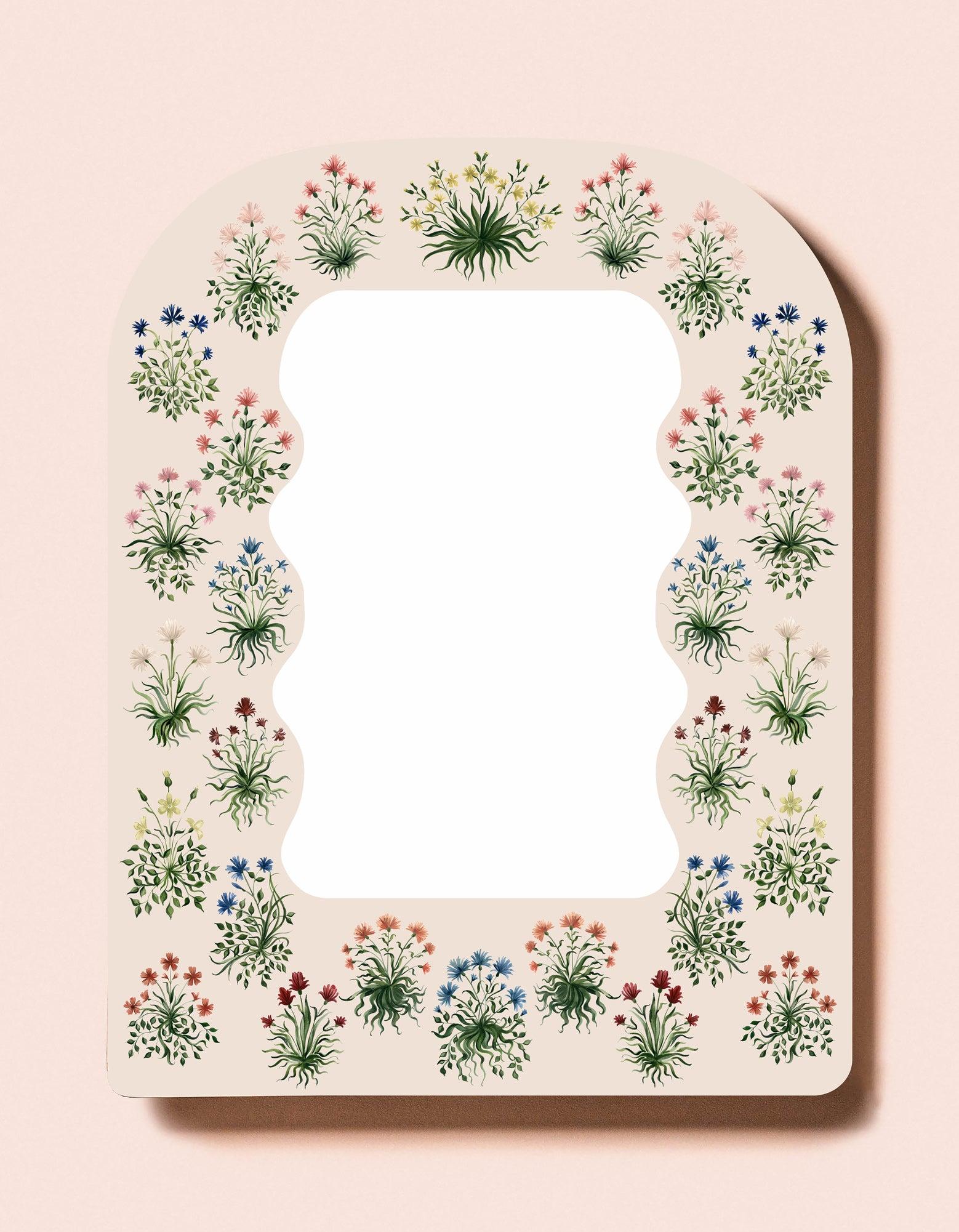 Created in collaboration with artist Riley Sheehay, our Jaipur mirror features her small, wispy hand-painted floral illustrations in a rounded, portail shape available in sizes small and large. Pigment and stain on wood produced from an original