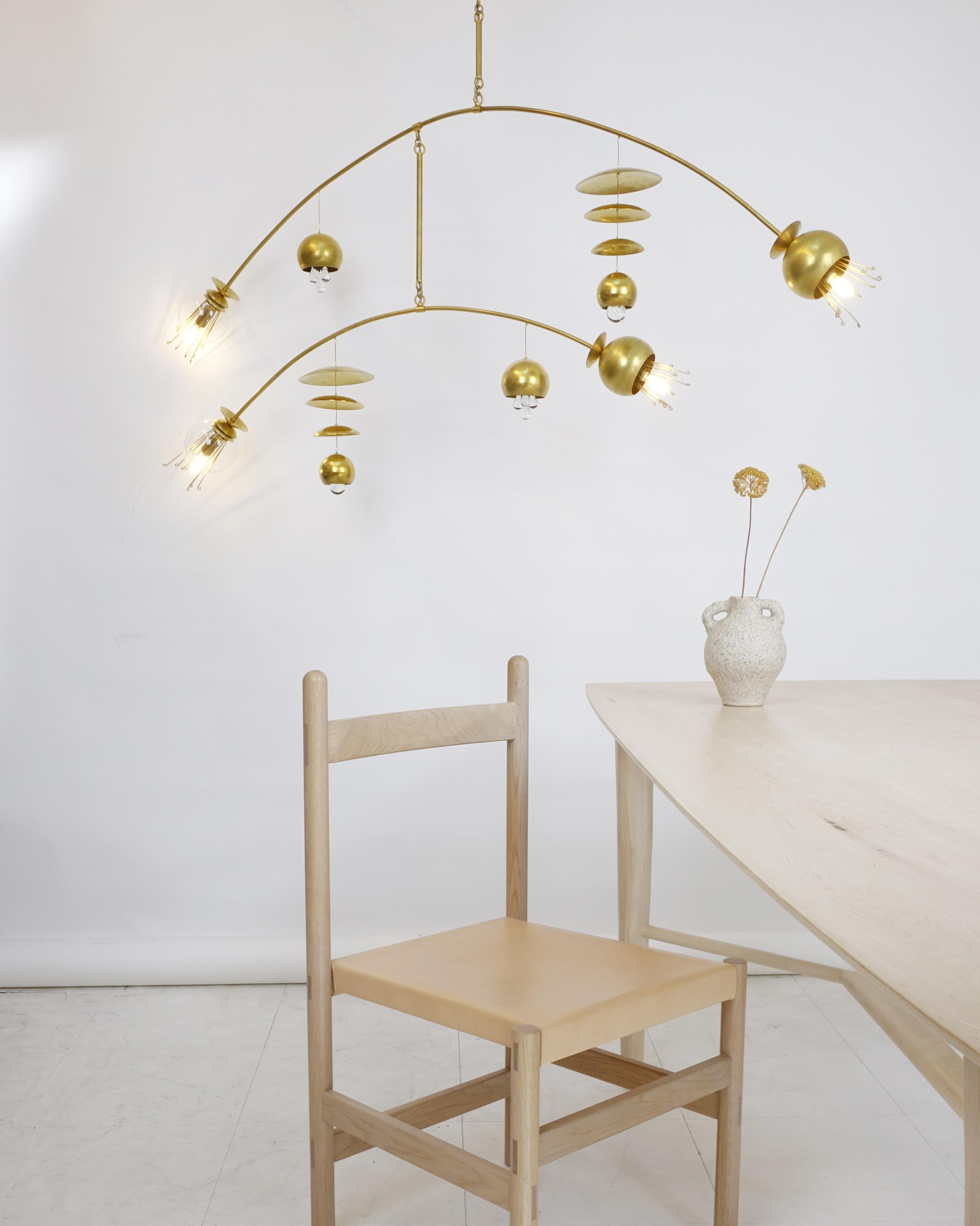 The Fleurish minor chandelier is a modern, organic mobile-style lighting
fixture designed by Michele Varian and built in our NYC studio. It is
solid brass construction with glass and crystal accents, mimicking flora
from Japanese imagery. The