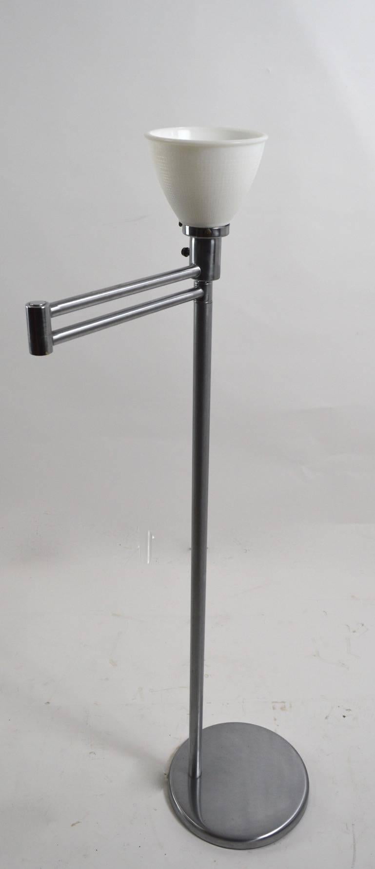 Classic flex arm floor lamp by Walter Von Nessen in clean, original, working condition.
Iconic design, exceptional quality construction. Slight dents to base.
Each segment of the swing arm is 12 inches (total extended length 24 inches).
This