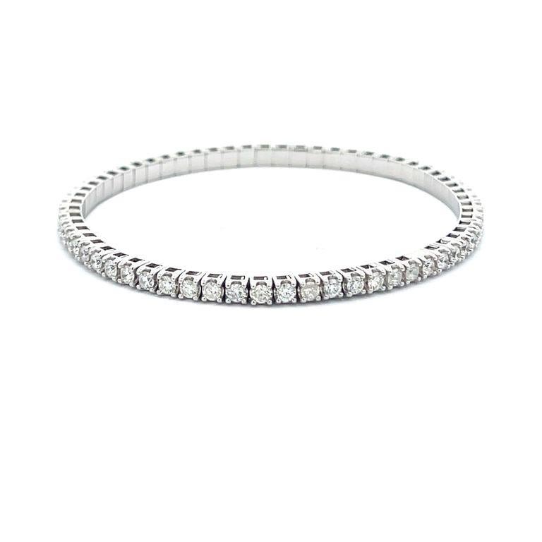 Diamond bangle bracelet in a flexible 14K white gold setting, this delicate and elegant piece features a row of round white diamonds with a total weight of 3.75 carats, these diamonds are G/H color and SI1/SI2 clarity, they are crafted in a 4-prong