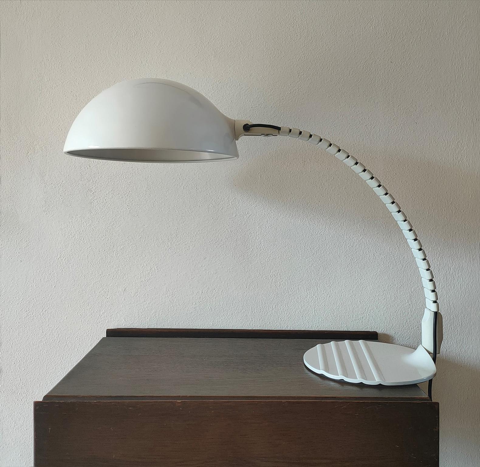 The Flex table lamp is an icon of the Italian historical design. 
The first Flex lamp, which present a clamp, was designed by Martinelli Luce in the late 1960s, the recent model also known as 660, which present a base was realized in 1972. 

The
