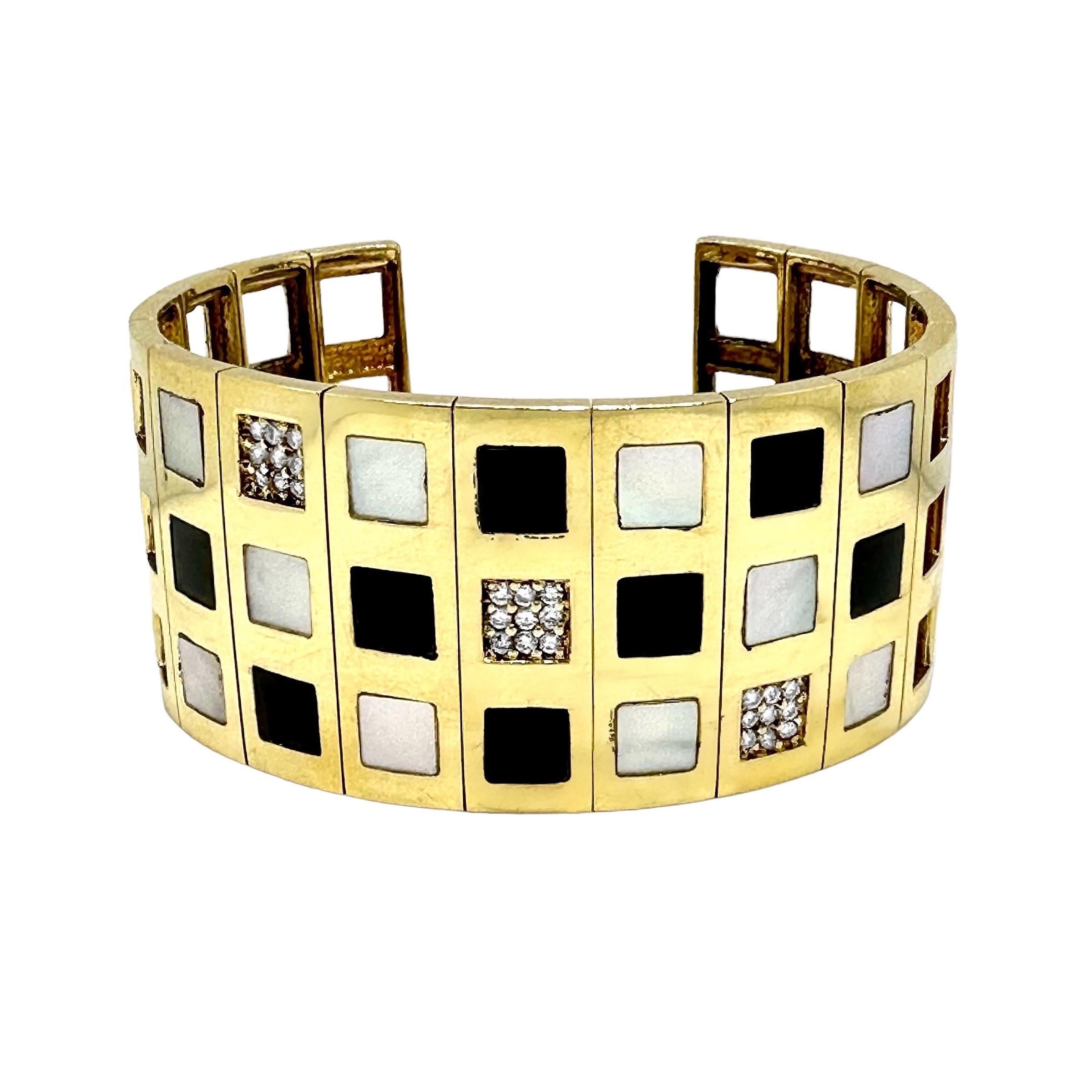 This truly striking and unmistakably 1960's bangle bracelet is set with mother of pearl, black onyx and diamond square panels. Total approximate diamond weight is .50ct of overall G/H color and VS2 clarity.  It is open at the back and easily flexes