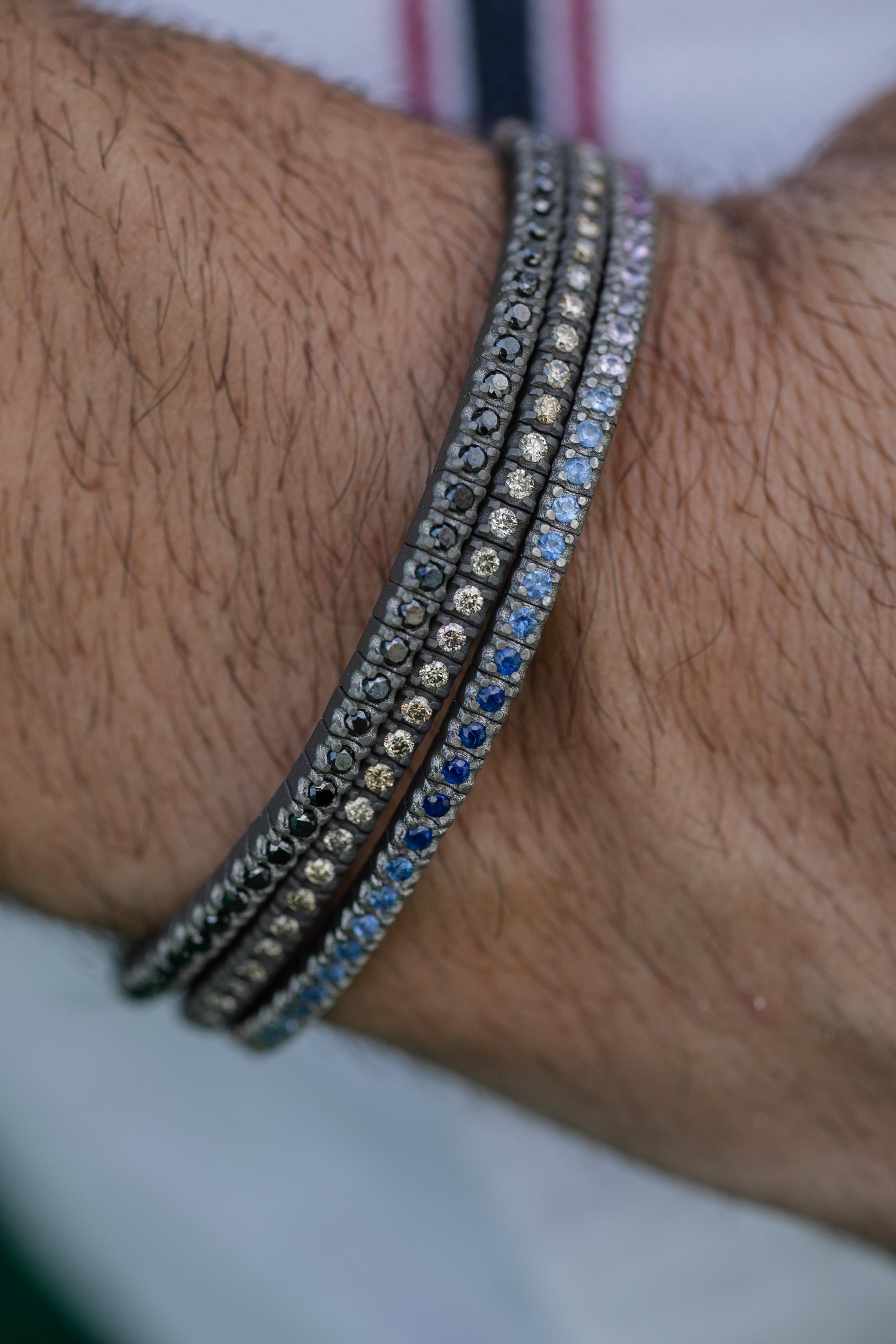This titanium flexible bracelet is from our Men's collection. Bracelet is decorated by beautiful natural multi-coloured sapphires in total of 3.20 Carat and with 18K rose gold details. The diameter of the bracelet is 6.5 cm. Perfect for daily