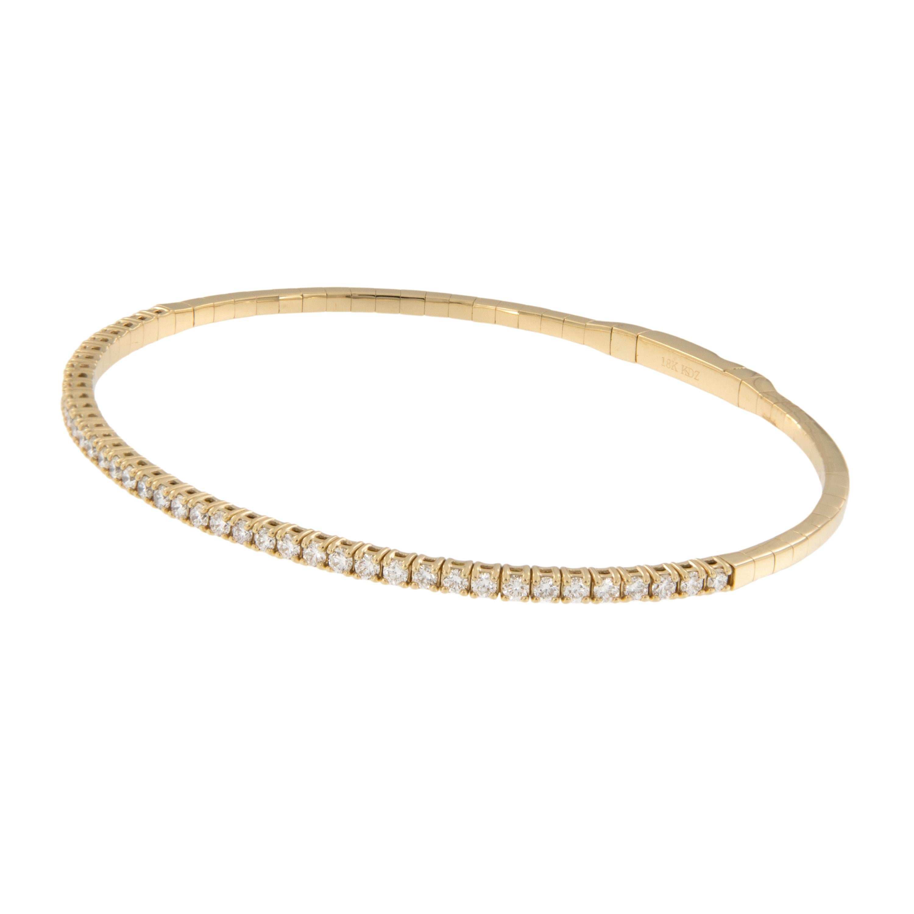 Worn on its own or stacked with other bangles, this piece is a staple in any jewelry collection. Made from fine 18 karat yellow gold and flexible set with 41 RBC diamonds = 1.00 Cttw of VS, F-G quality this bracelet will feel just at home on your